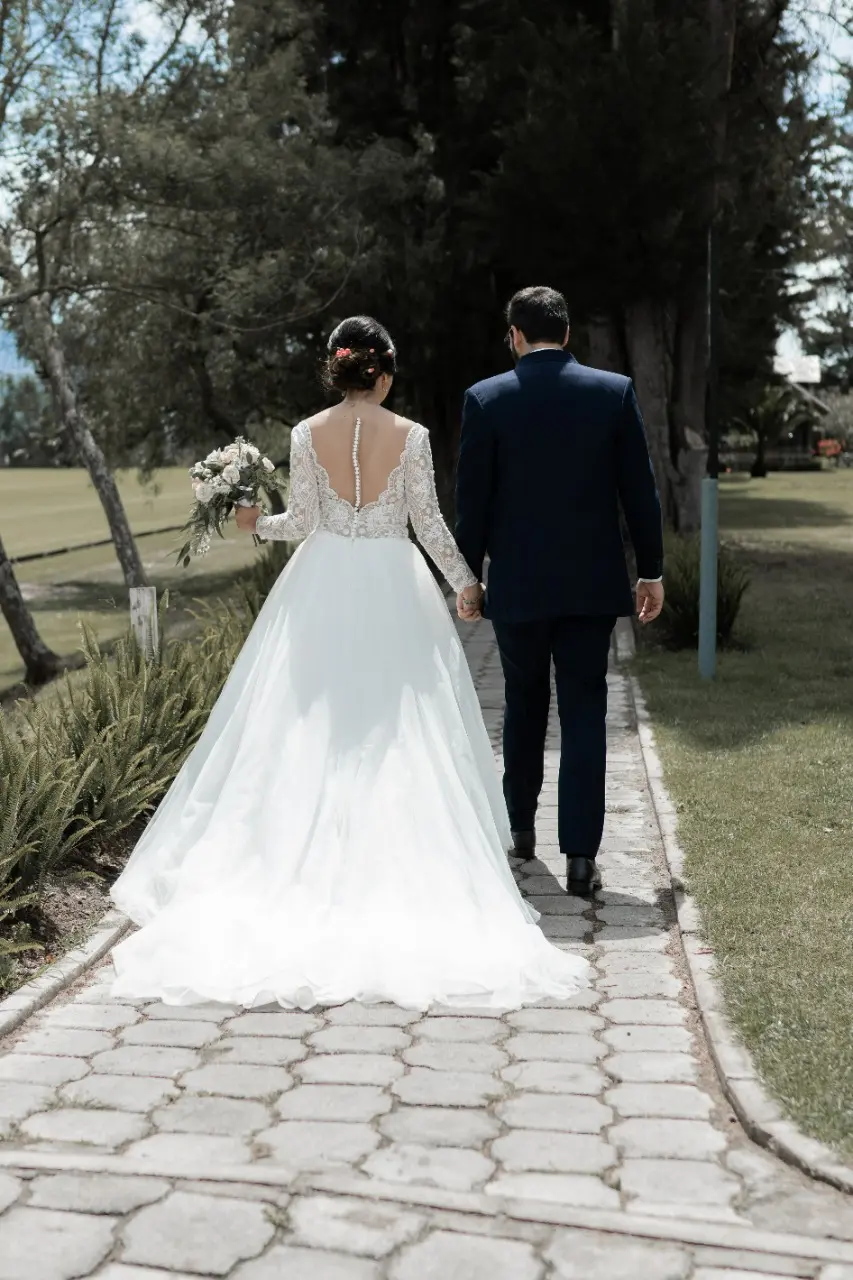 Bride in Long Sleeve Ball Gown Wedding Dress Named Mallory Dawn by Maggie Sottero with Groom