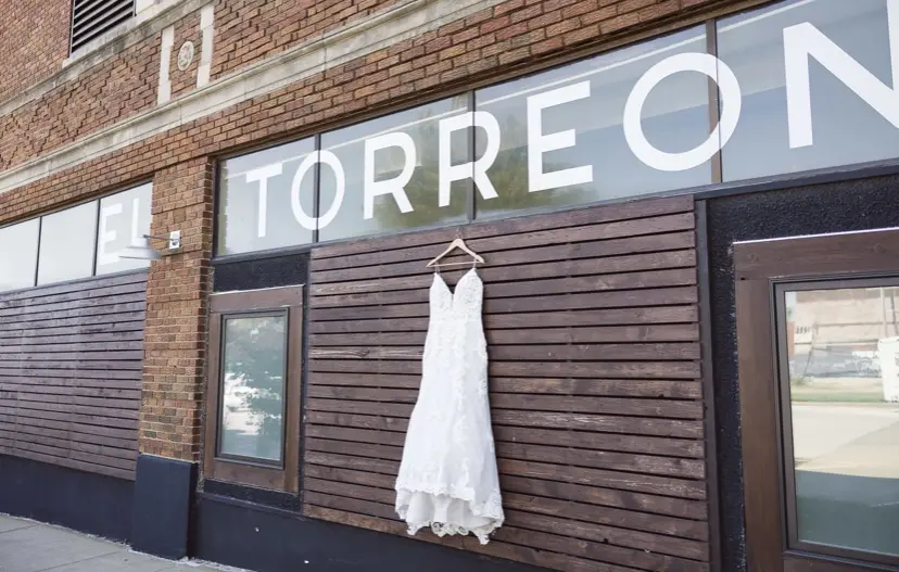 Wedding dress called Tuscany Lane hanging outside venue.