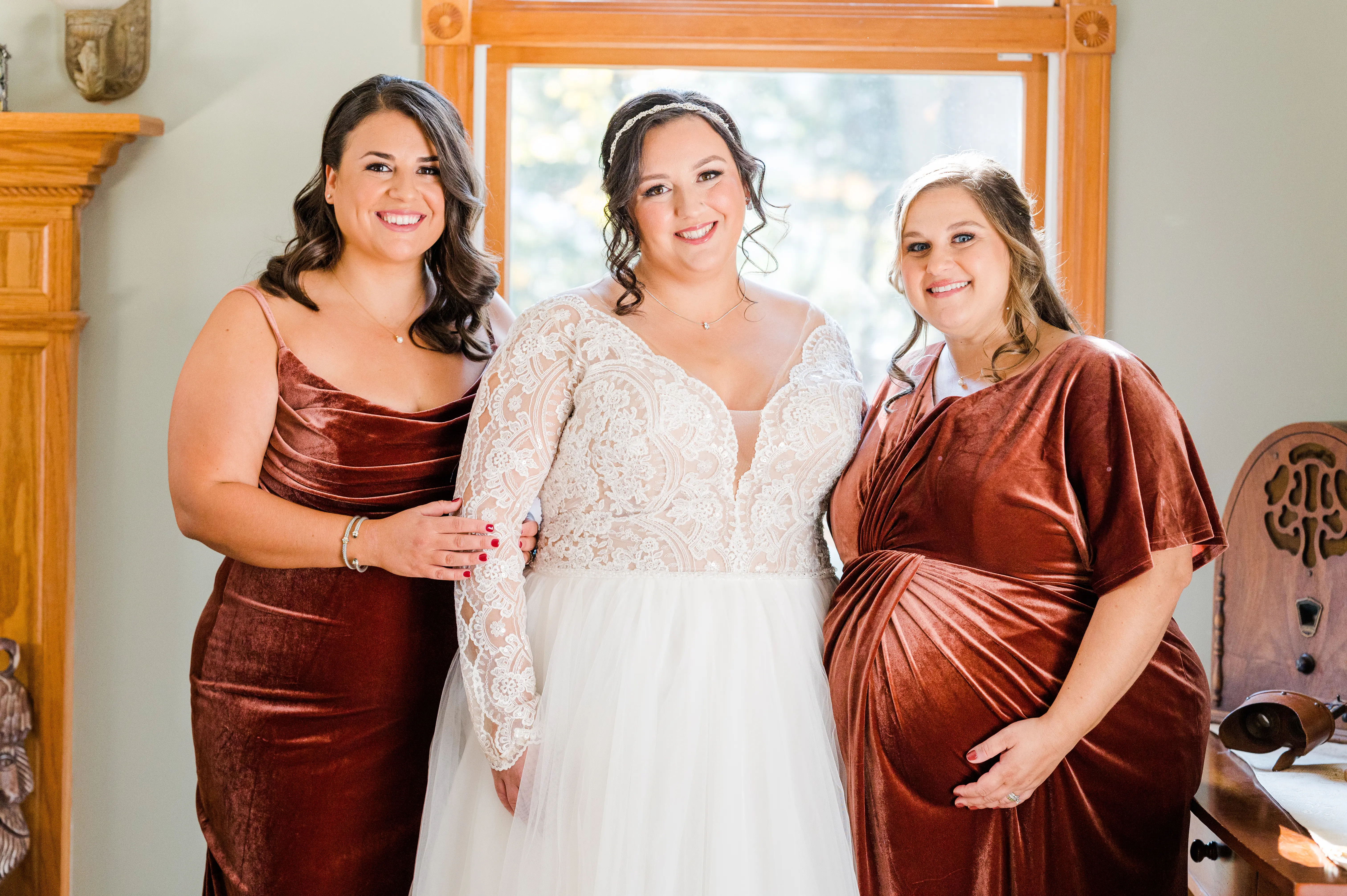 Bride With Bridesmaids Together. Bride Wearing Long Sleeve Lace Ball Gown With Tulle Skirt Called Mallory Dawn By Maggie Sottero