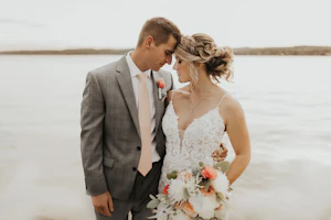 Bride Wearing Lace Sexy Wedding Dress Called Tuscany Lynette By Maggie Sottero With Groom By A Lake
