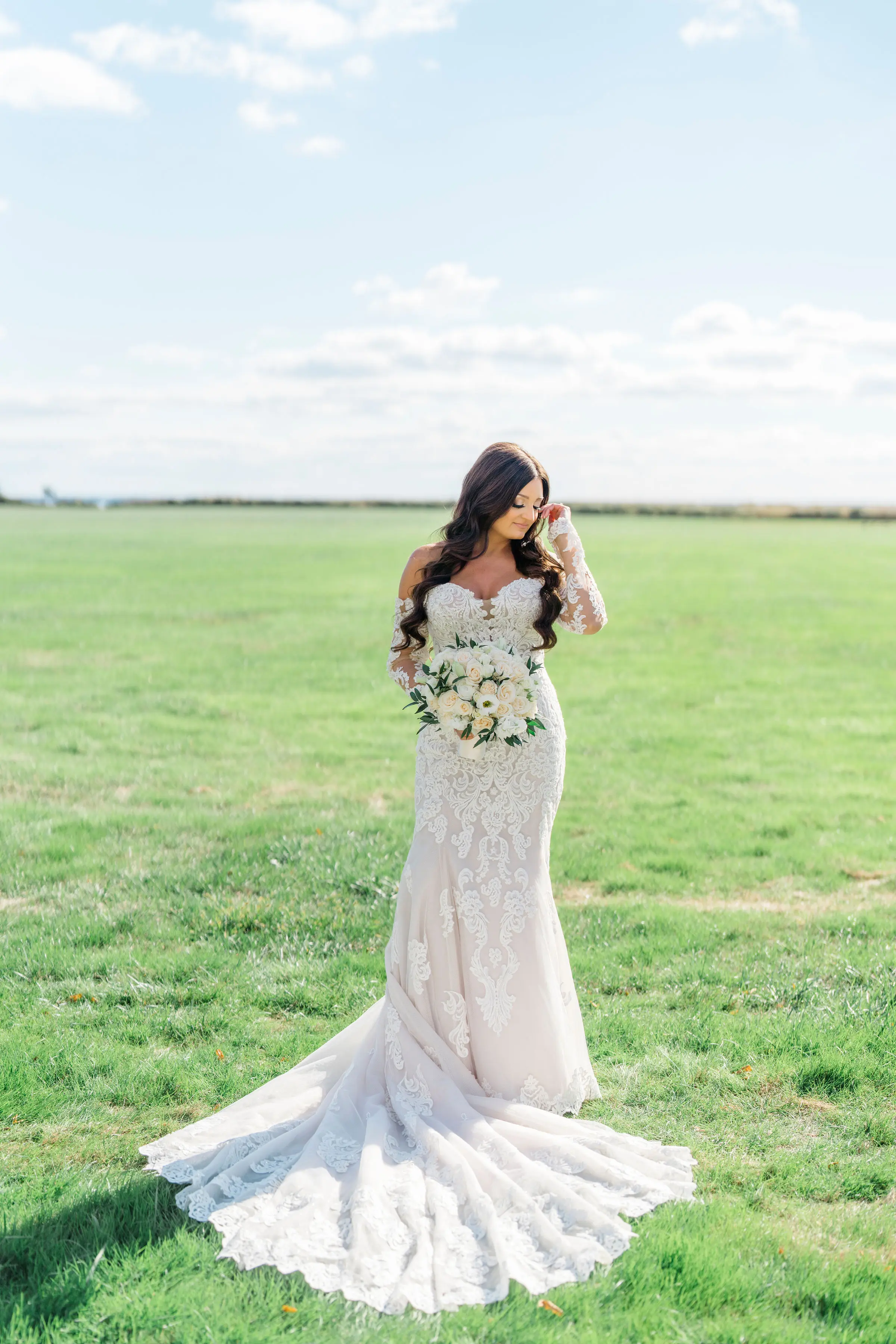 Bride Wearing Sparkly Lace Fit-and-Flare Wedding Dress in Field Outdoors.