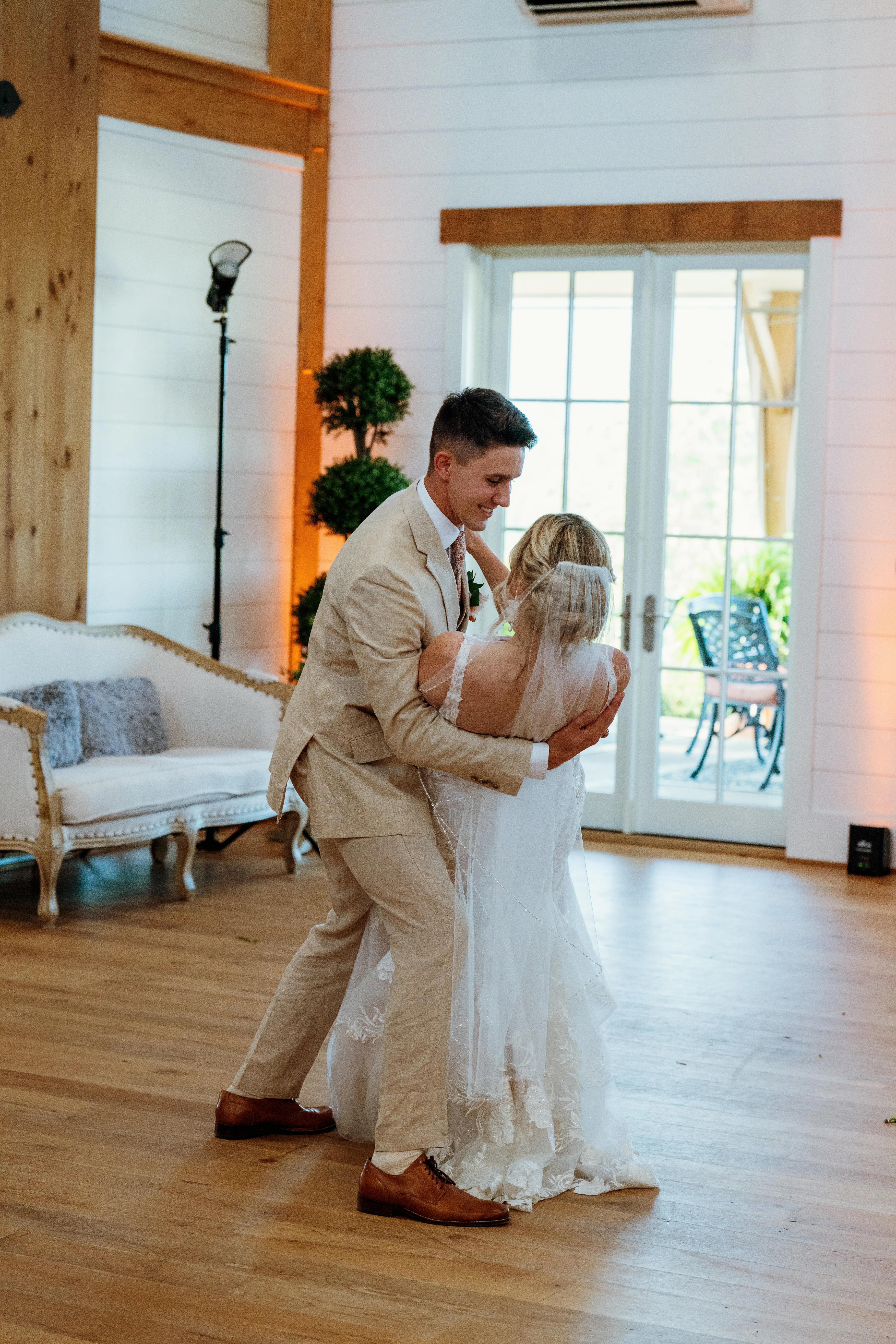 Bride wearing Albany wedding dress by Maggie Sottero dancing with her husband