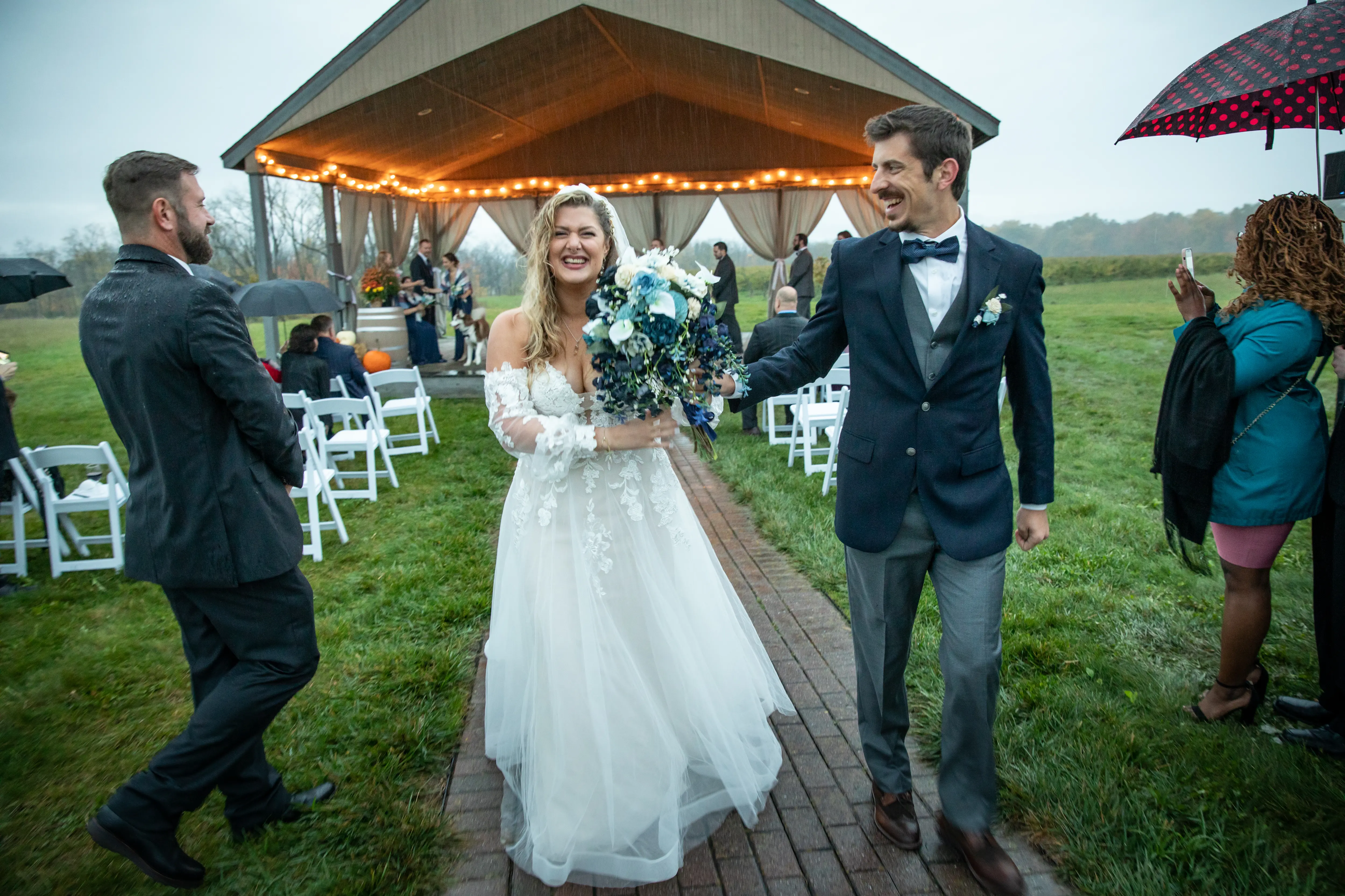 Bride Wearing Boho A-Line Wedding Dress Called Stevie By Maggie Sottero Walking In The Rain