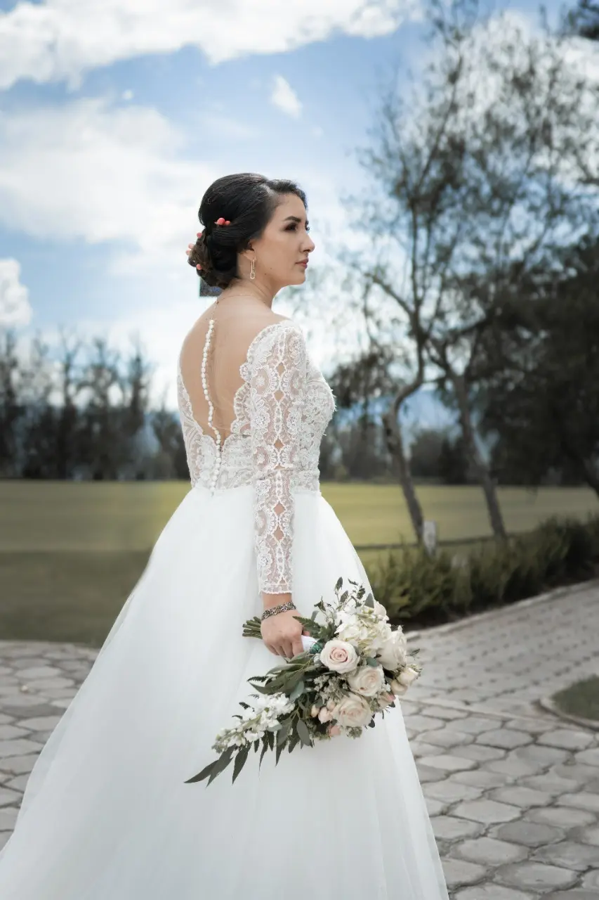 Bride in Long Sleeve Ball Gown Wedding Dress Named Mallory Dawn by Maggie Sottero