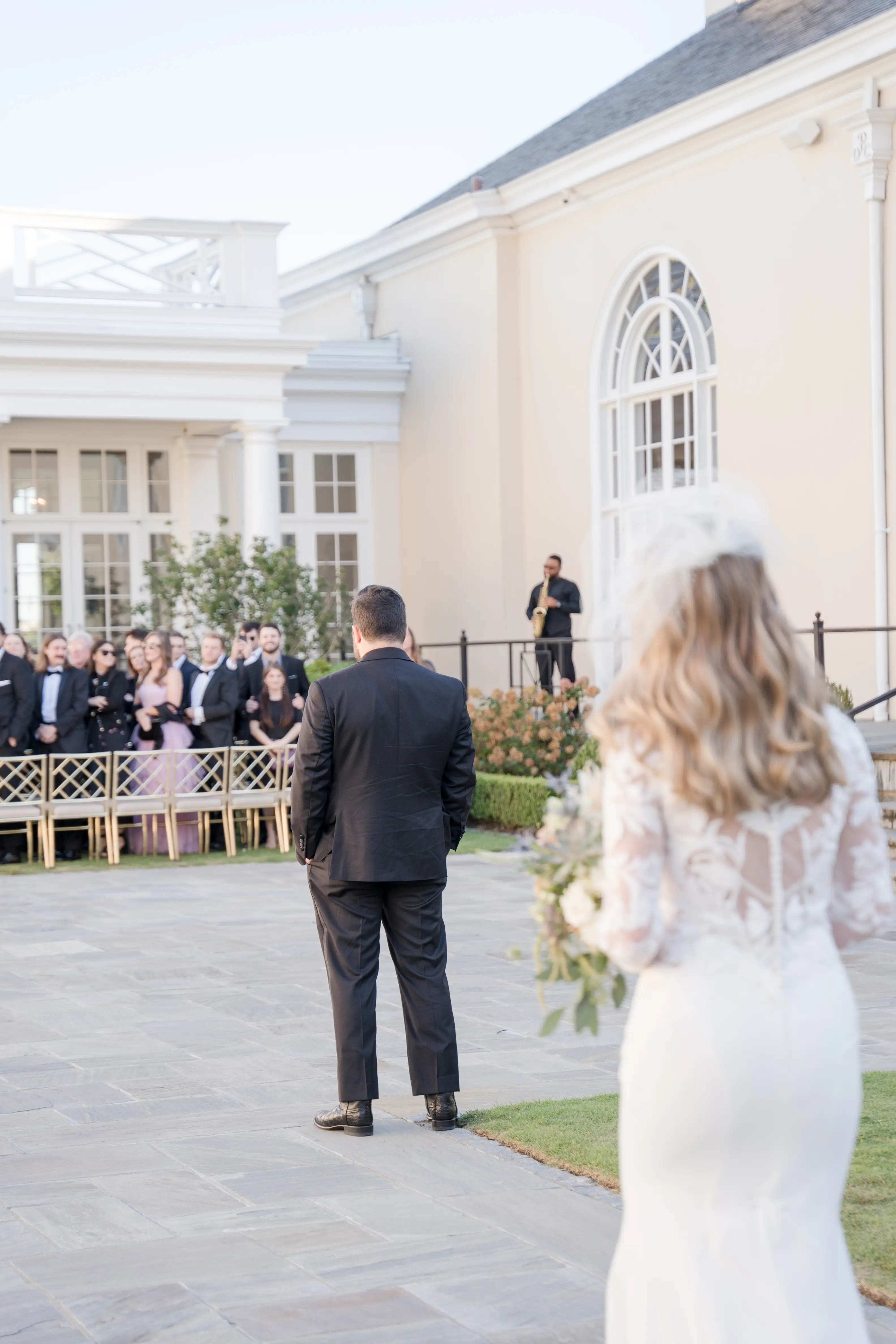 Bride wearing Dionne wedding dress by Rebecca Ingram doing first look with her husband