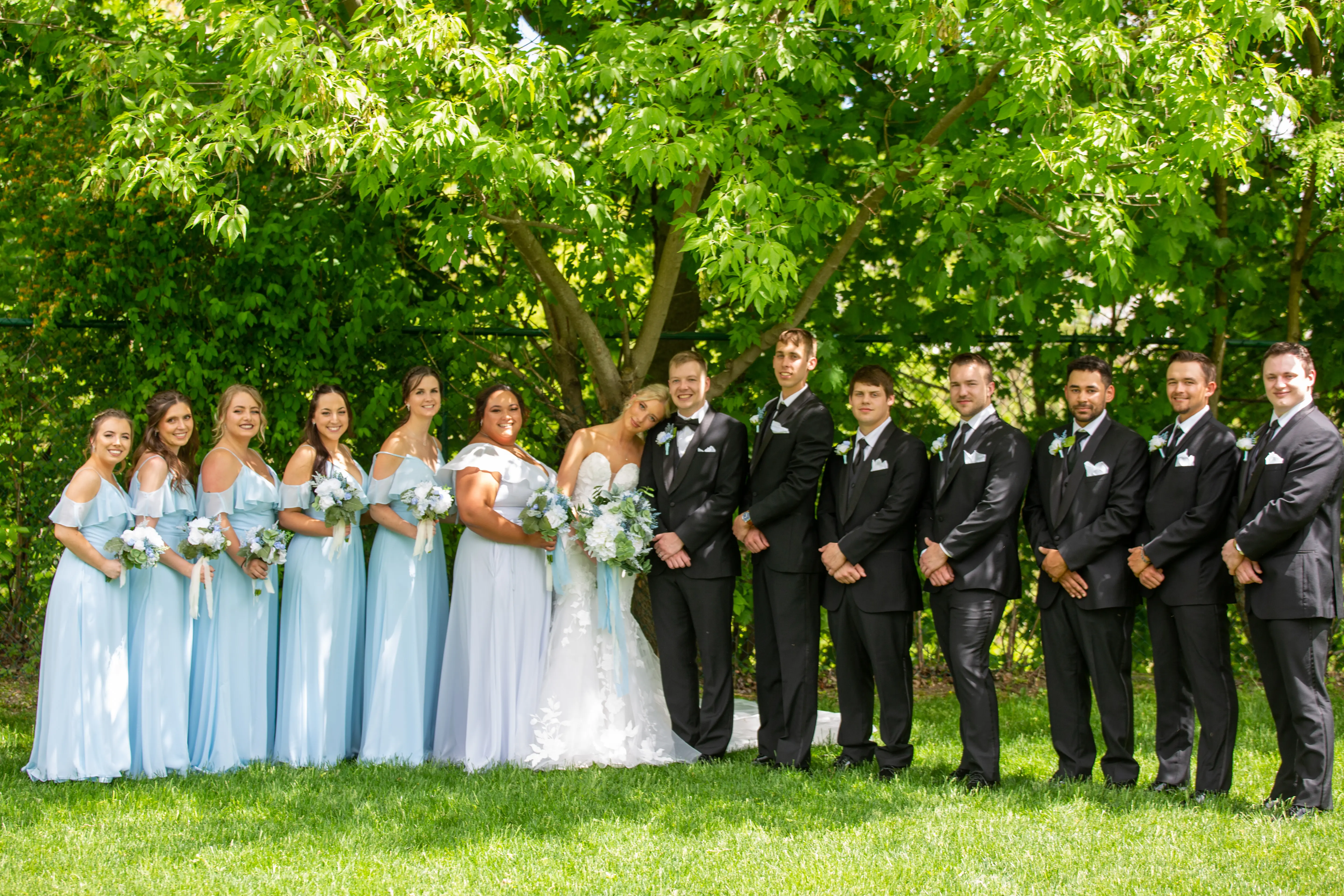 Wedding Party with Real Bride in Strapless Mermaid Bridal Gown with Oversized Floral Lace Motifs over Sparkle Tulle called Hattie by Rebecca Ingram