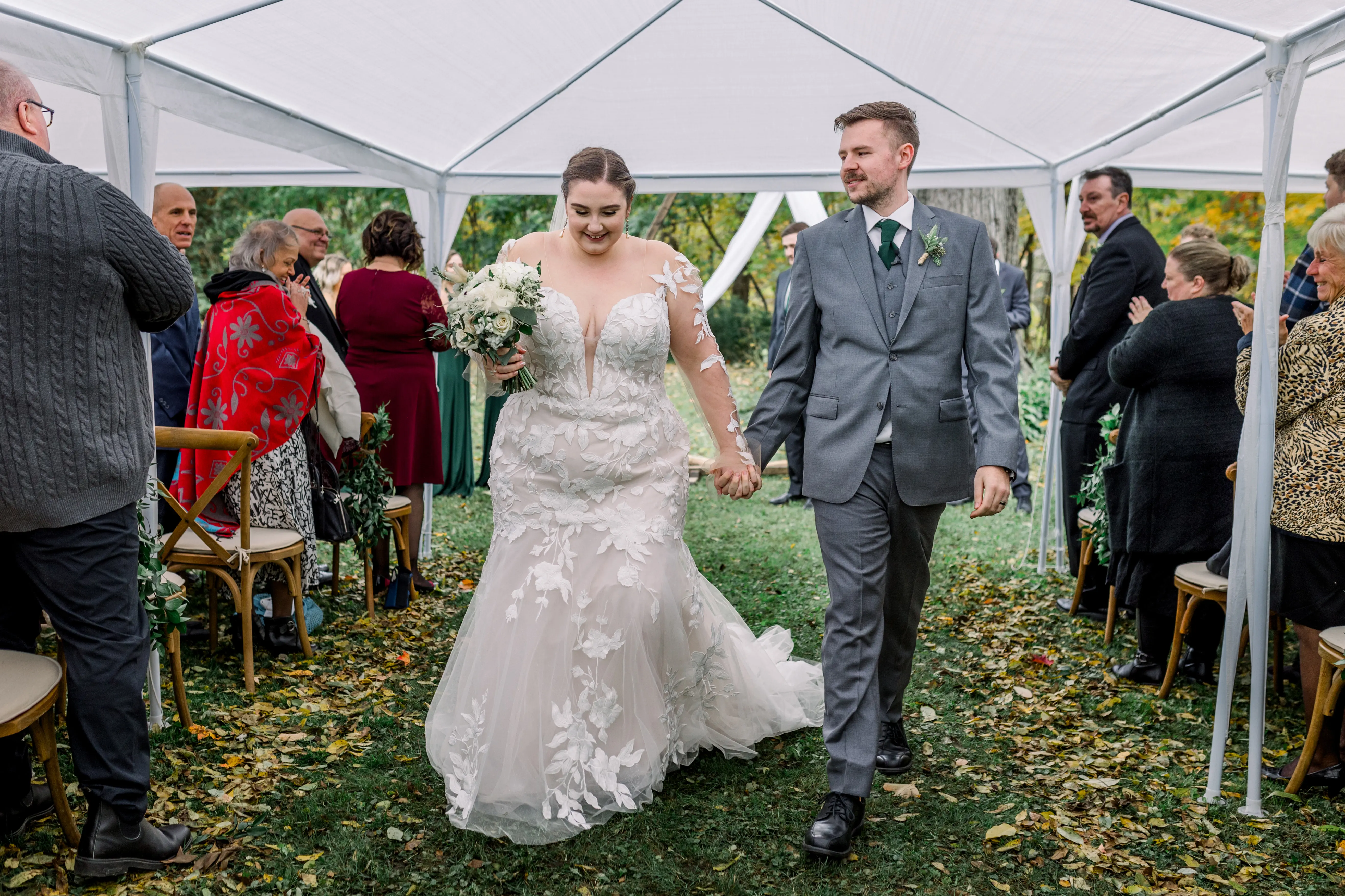 Bride wearing Hattie by Rebecca Ingram holding hands with her husband