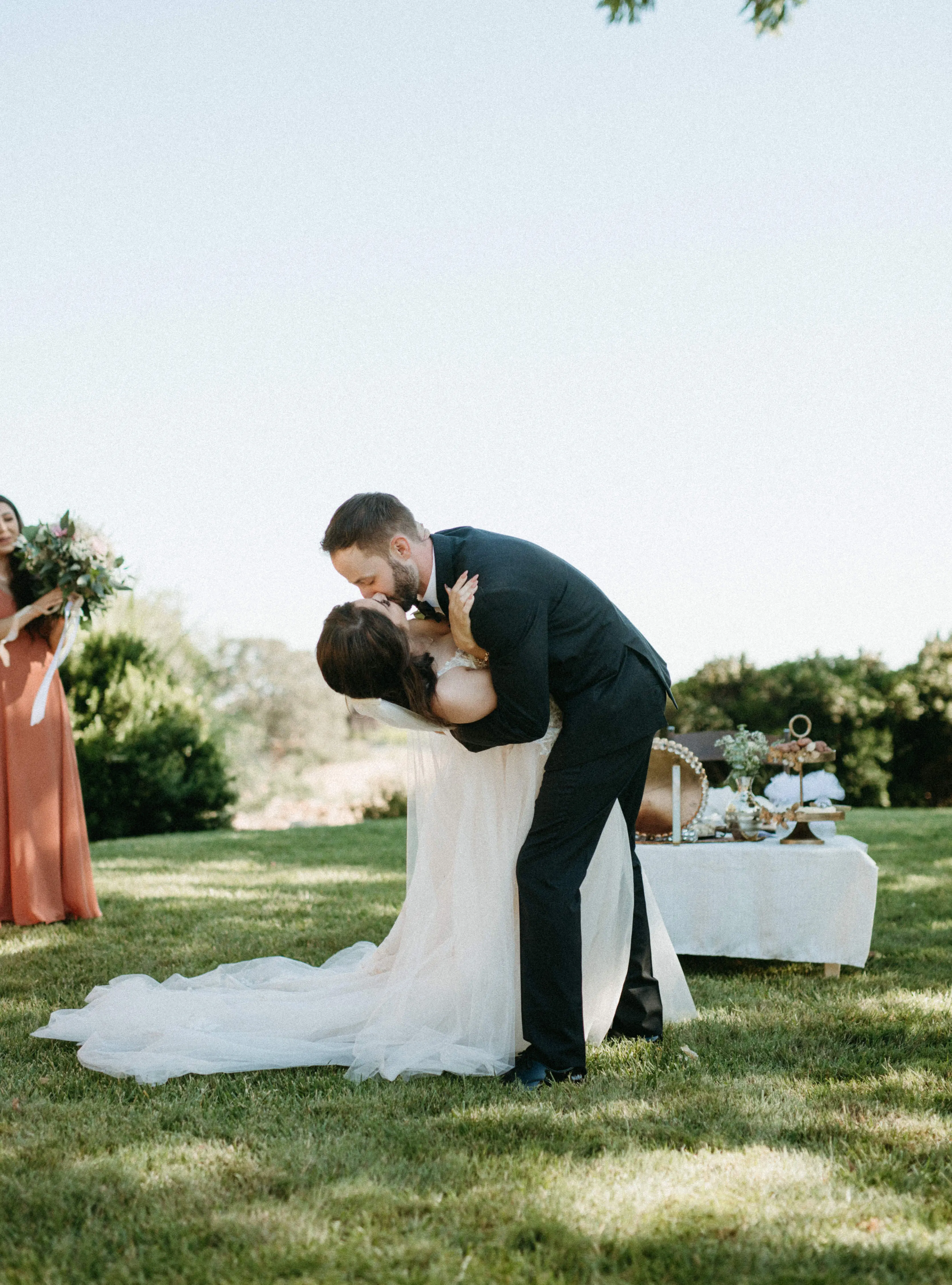 Groom Kissing Bride in Magical A-Line Wedding Dress with Textured Illusion Motifs Called Minerva by Rebecca Ingram