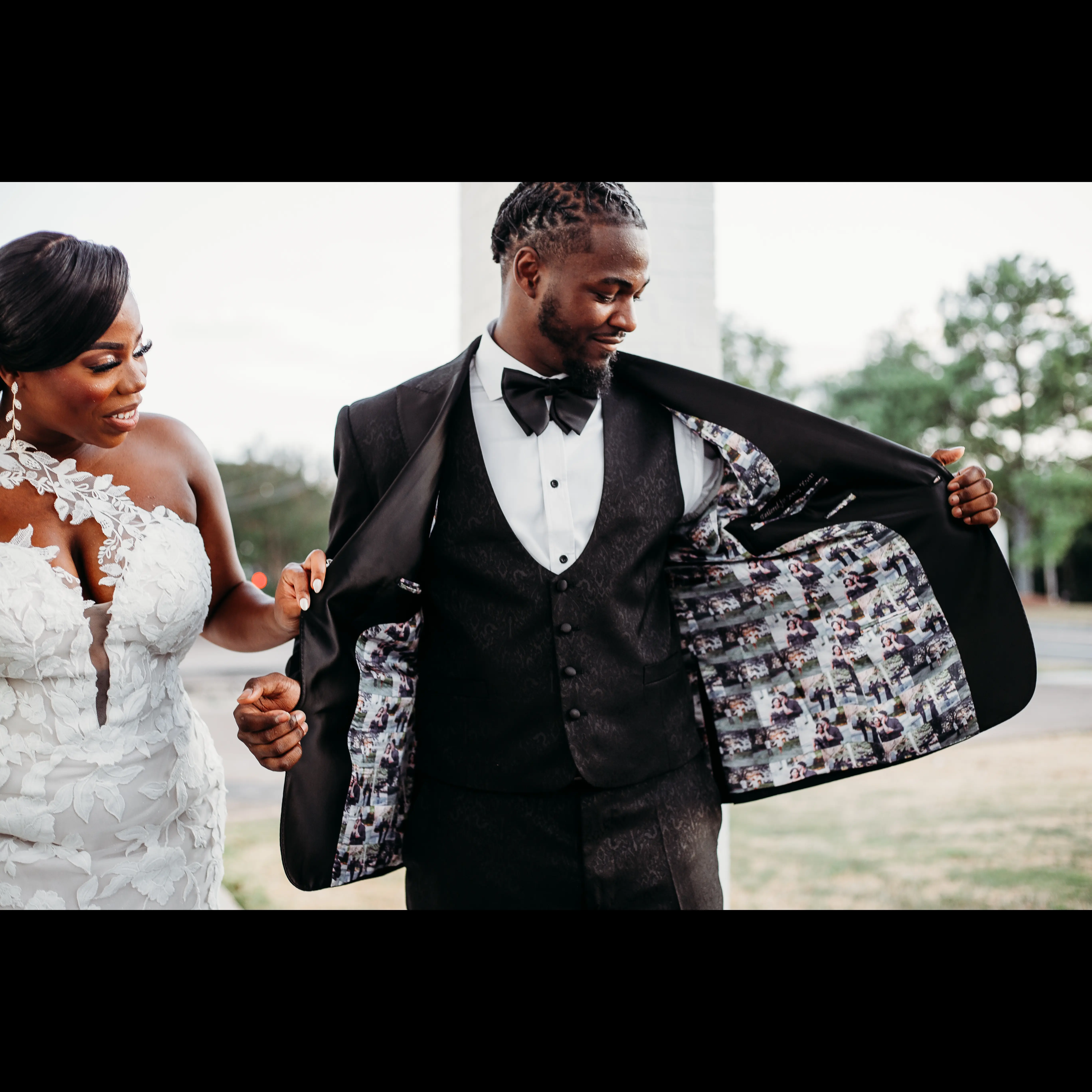 Bride wearing Hattie by Rebecca Ingram and her husband showing off his suit jacket