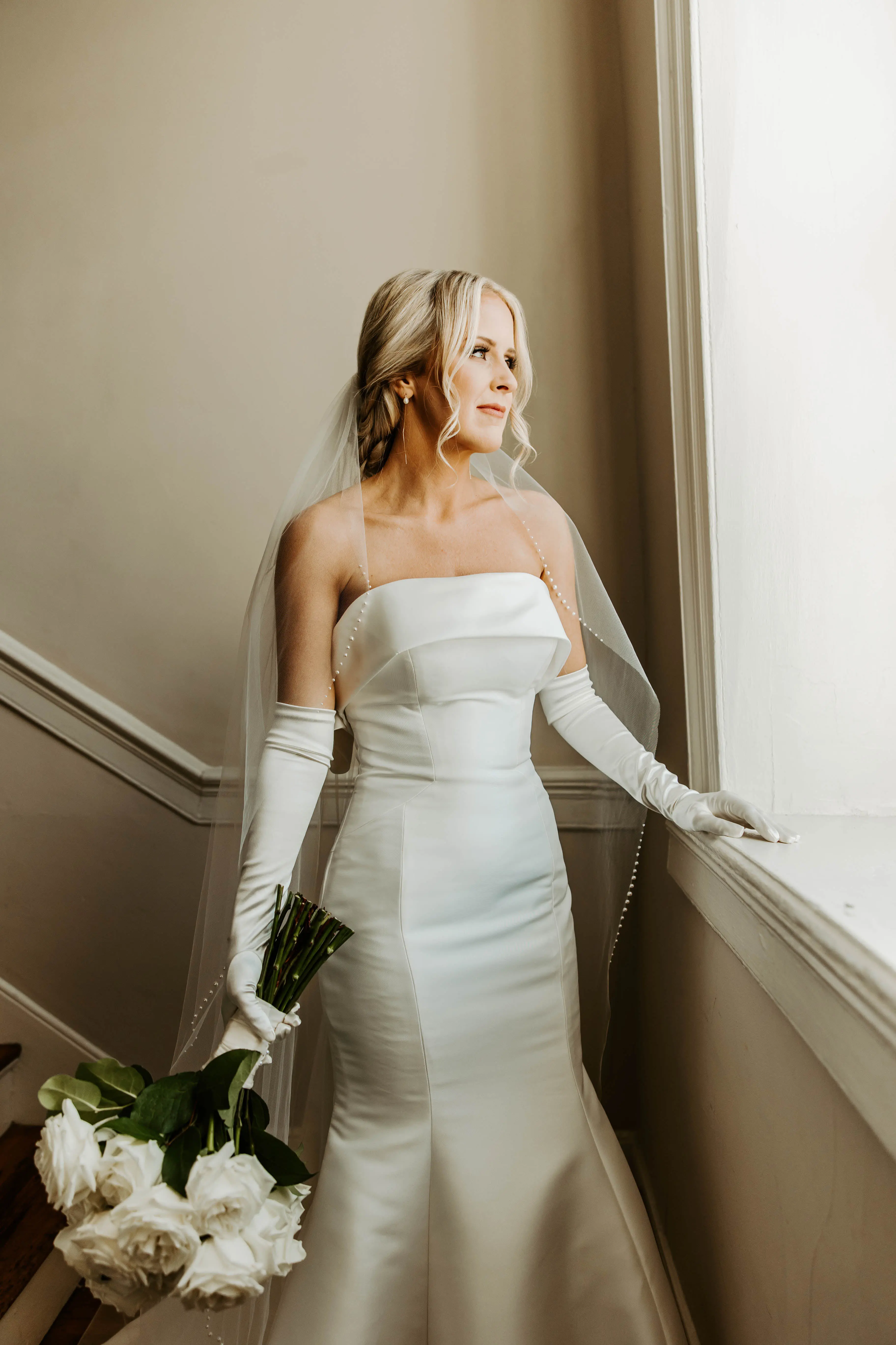 Bride Wearing A White Fit And Flare Wedding Dress Named Mitchell By Maggie Sottero With Long Gloves