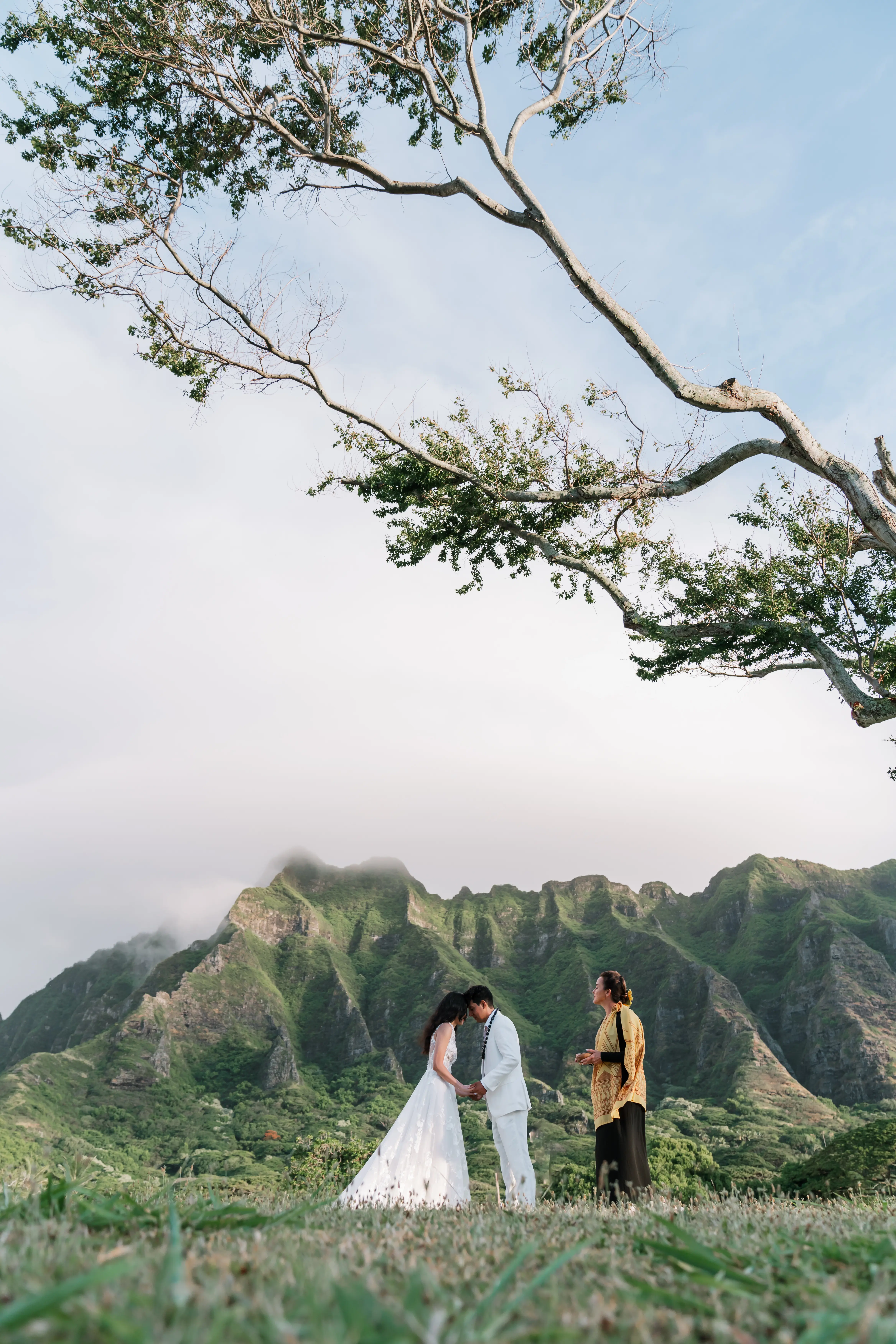 Bride wearing Winter by Maggie Sottero touches foreheads with her husband