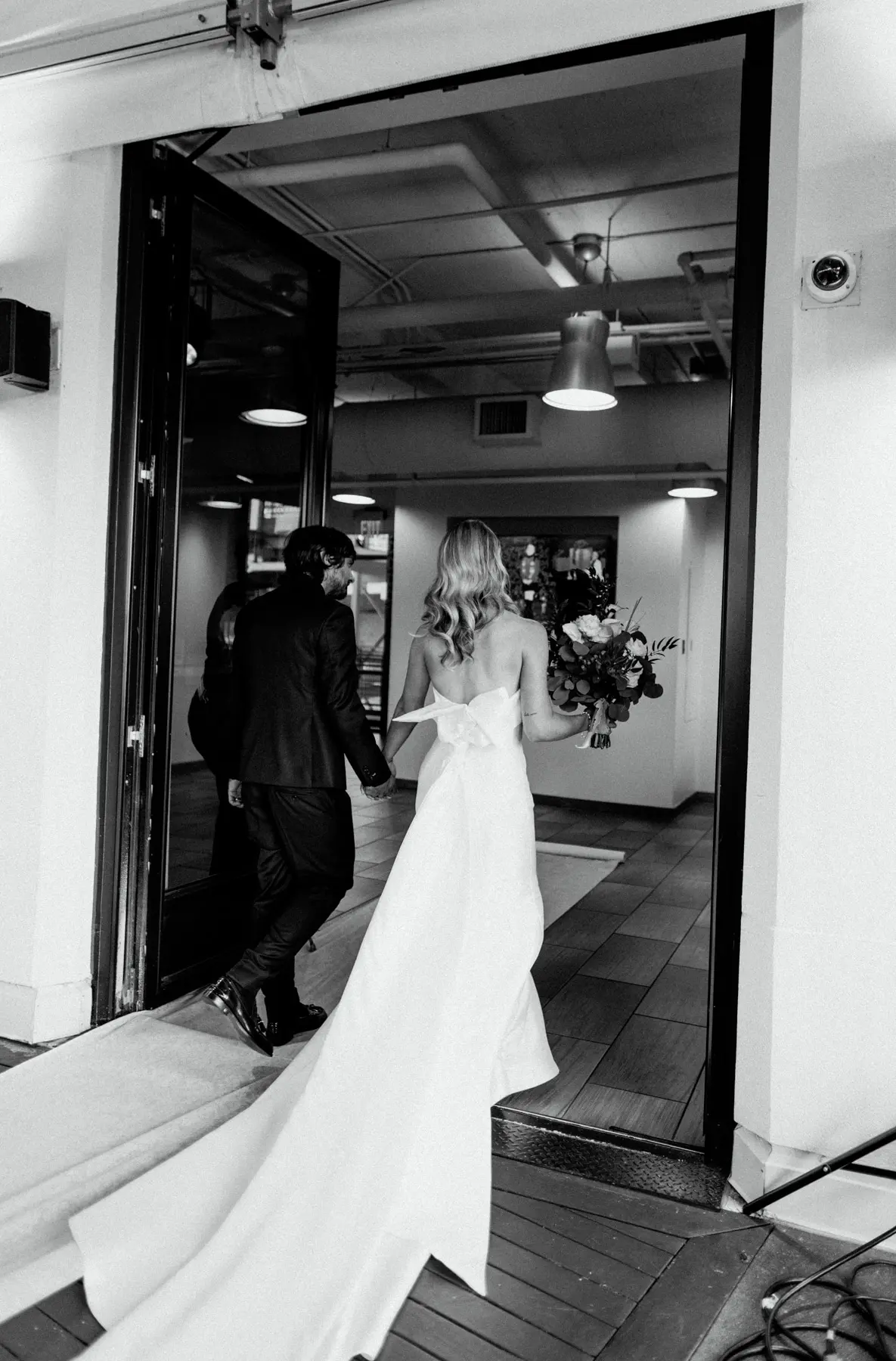 Groom With Bride Wearing Unique Strapless Wedding Dress With Beautiful Back Bow Mitchell By Maggie Sottero