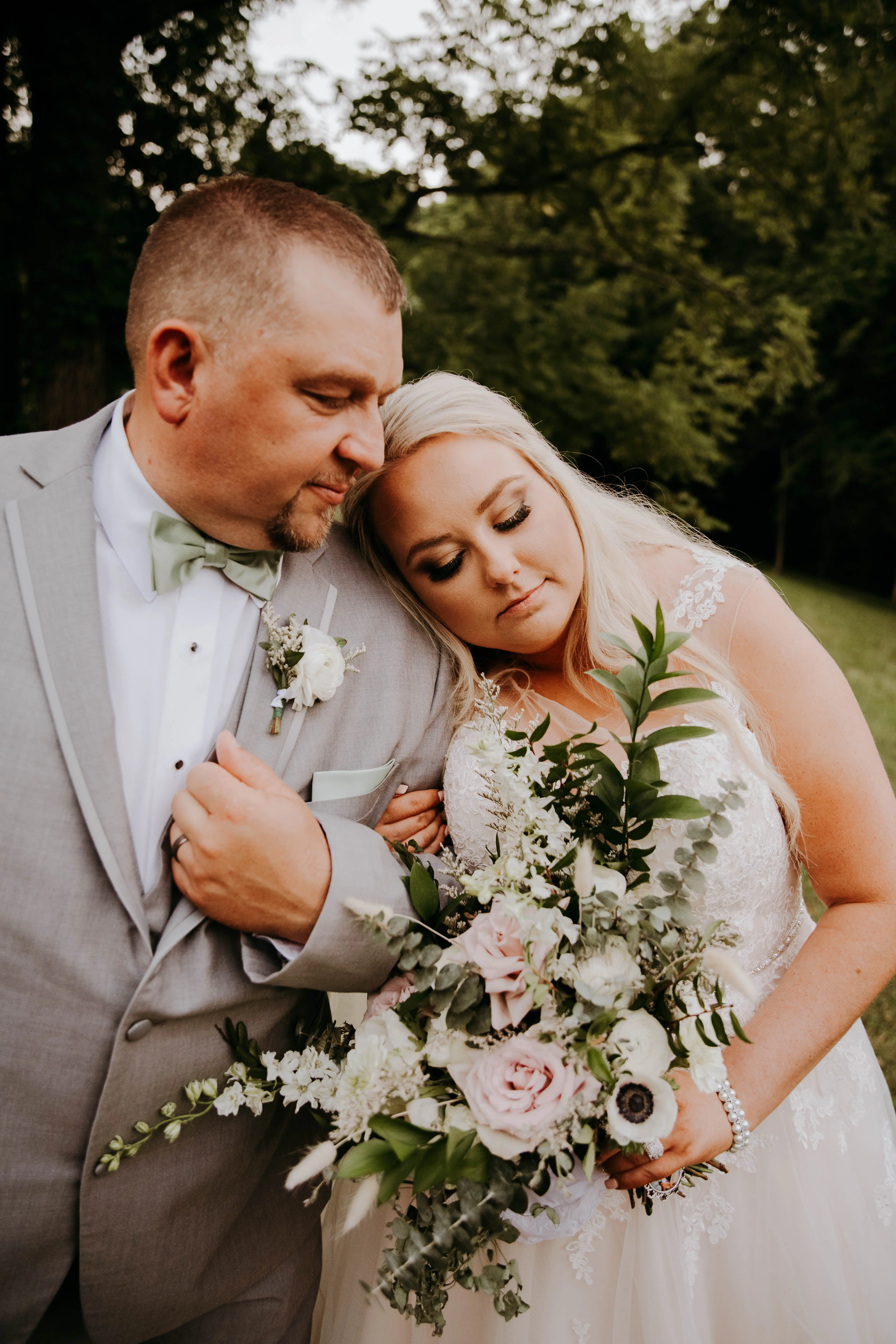 Groom and Bride at an Outdoor Wedding Wearing Lace Ballgown Wedding Dress Called Olivia by Rebecca Ingram