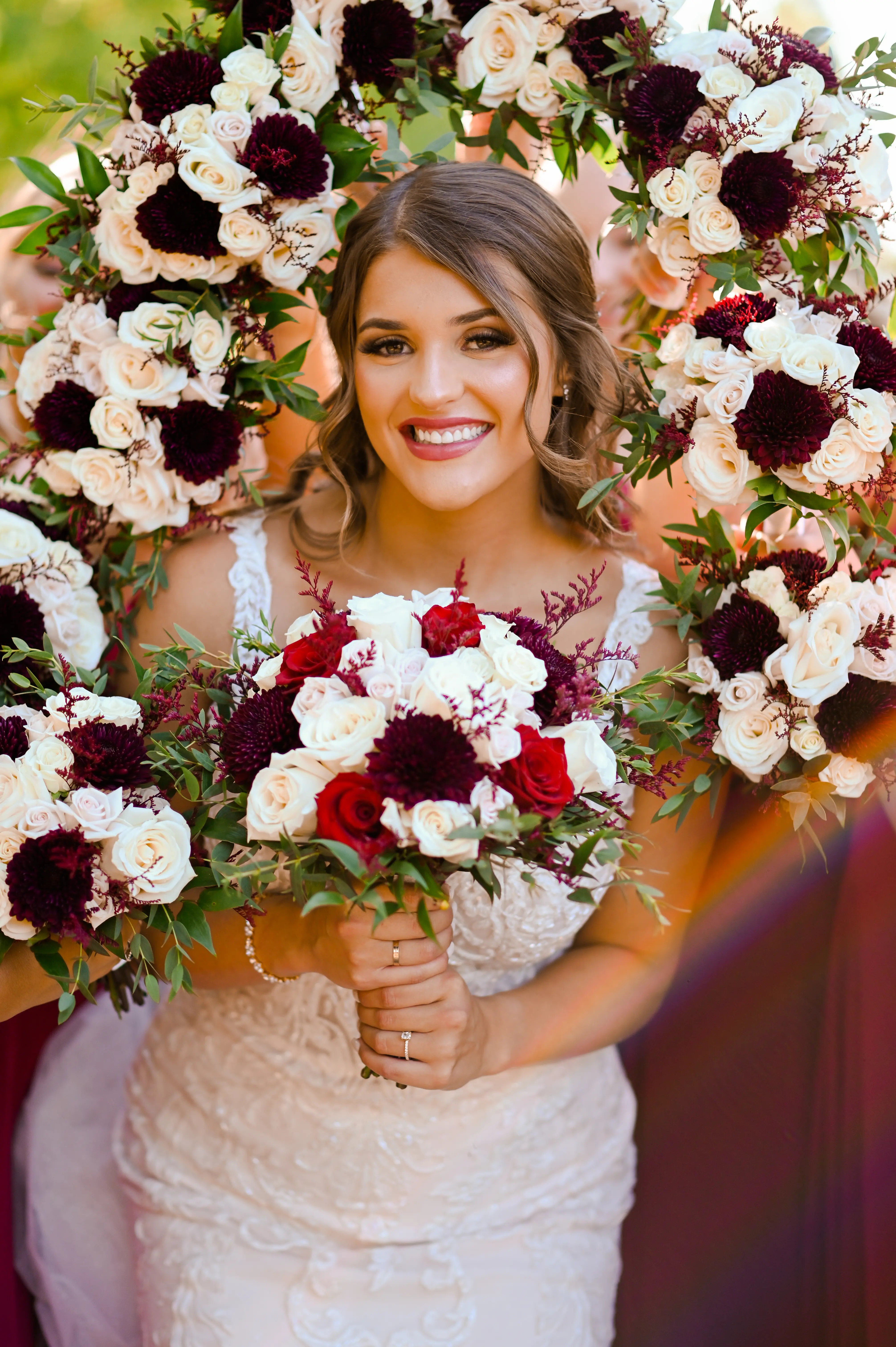 Bride wearing Hamilton wedding dress by Sottero and Midgley surrounded by bouquets