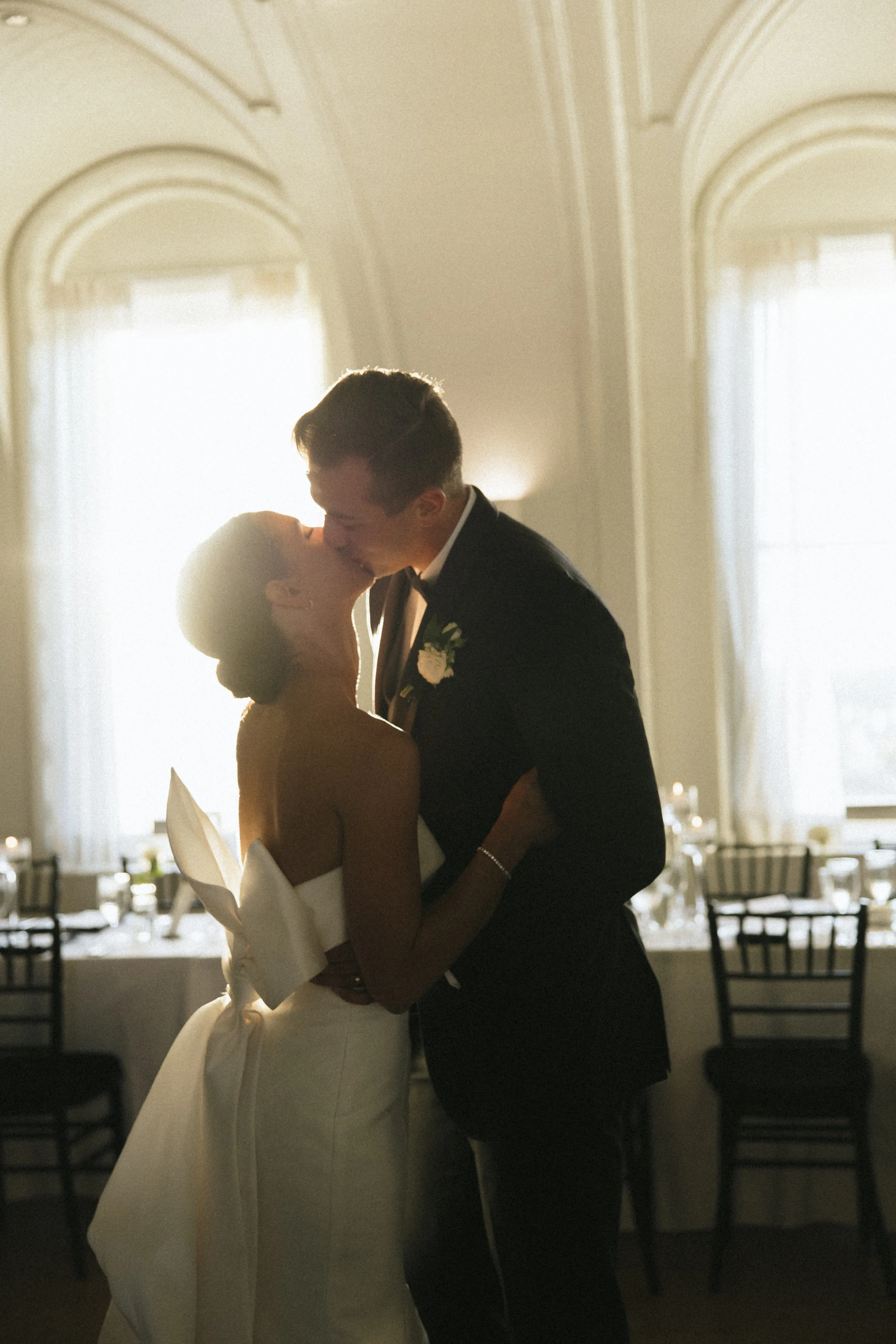 Bride wearing Mitchell wedding dress by Maggie Sottero kissing her husband