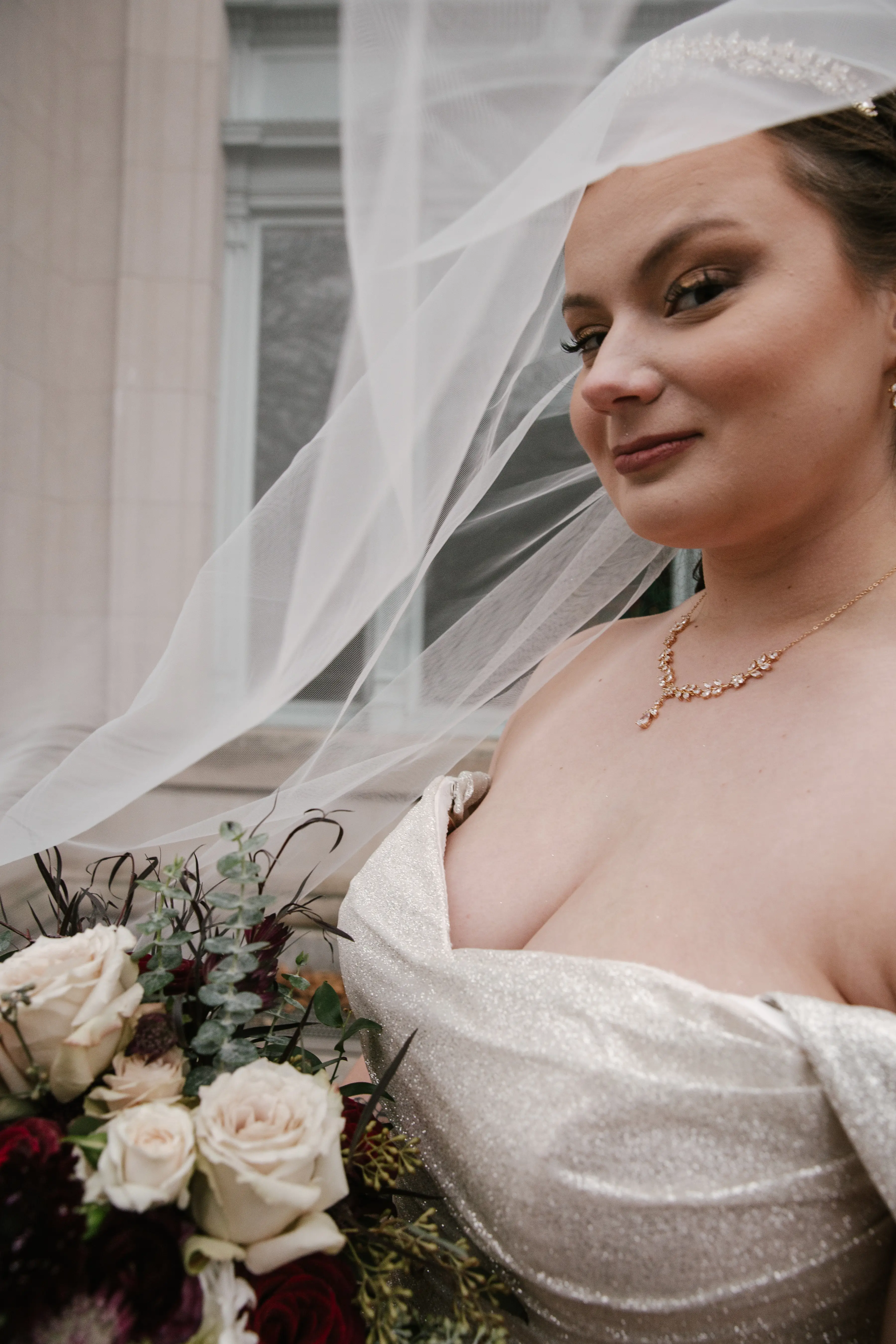 Bride in Wedding Dress With Sparkles Named Anniston By Maggie Sottero With Veil And Flowers