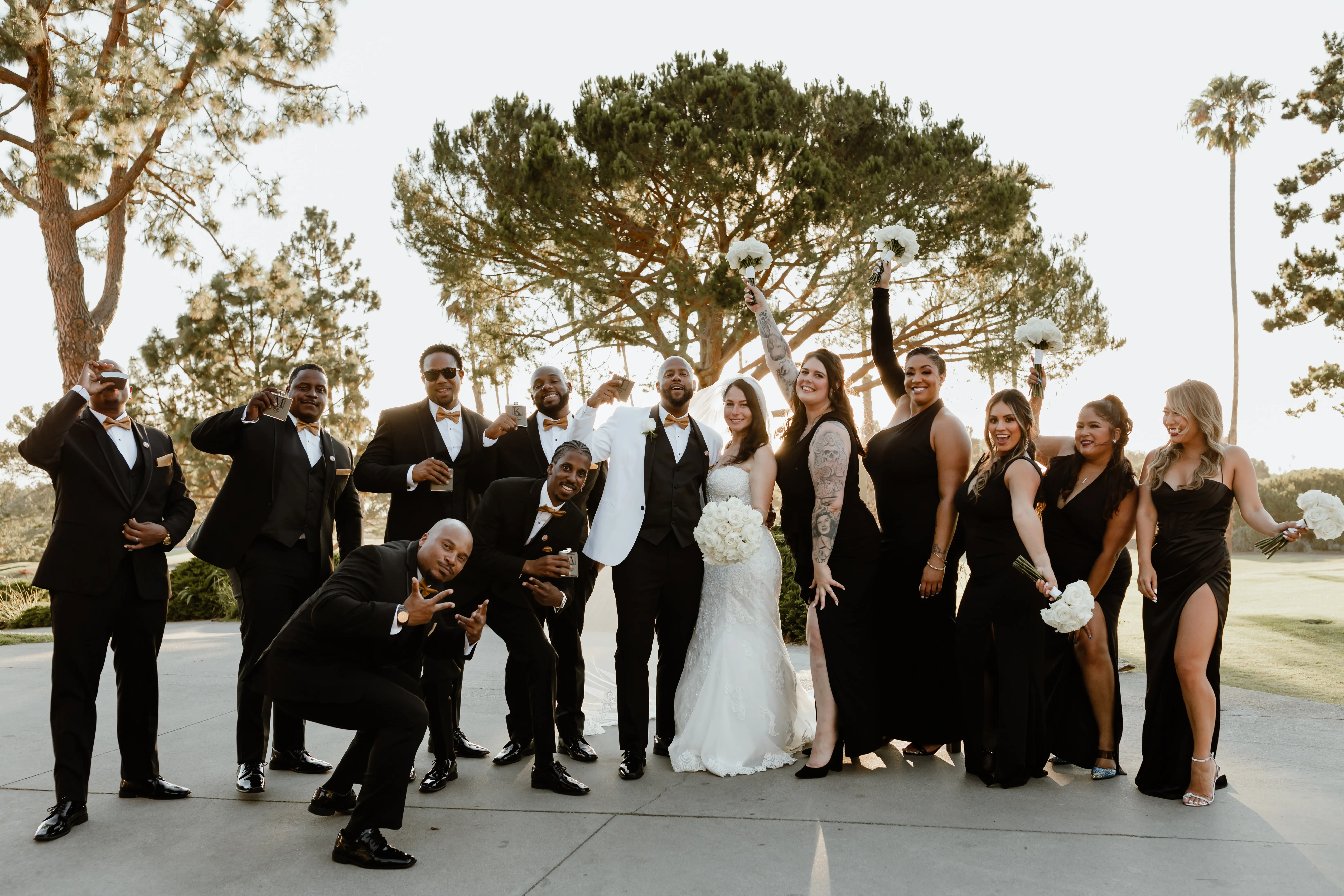 Bride In Beach lace Wedding Dress Called Fiona By Maggie Sottero With Bridal Party In Black And Orange With Groom In White Suit