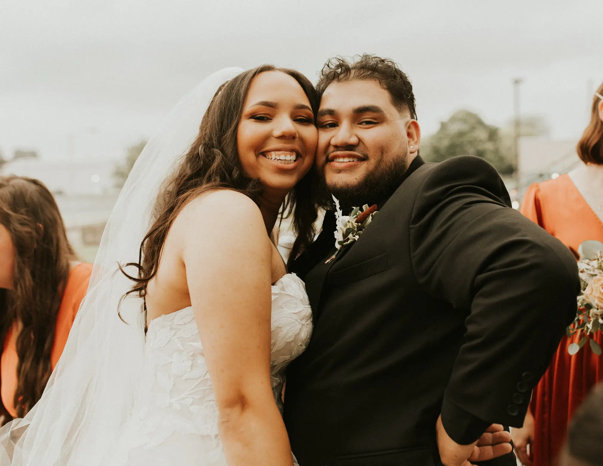 Bride and Groom Hugging Wearing Bridal Gown Called Hattie by Rebecca Ingram