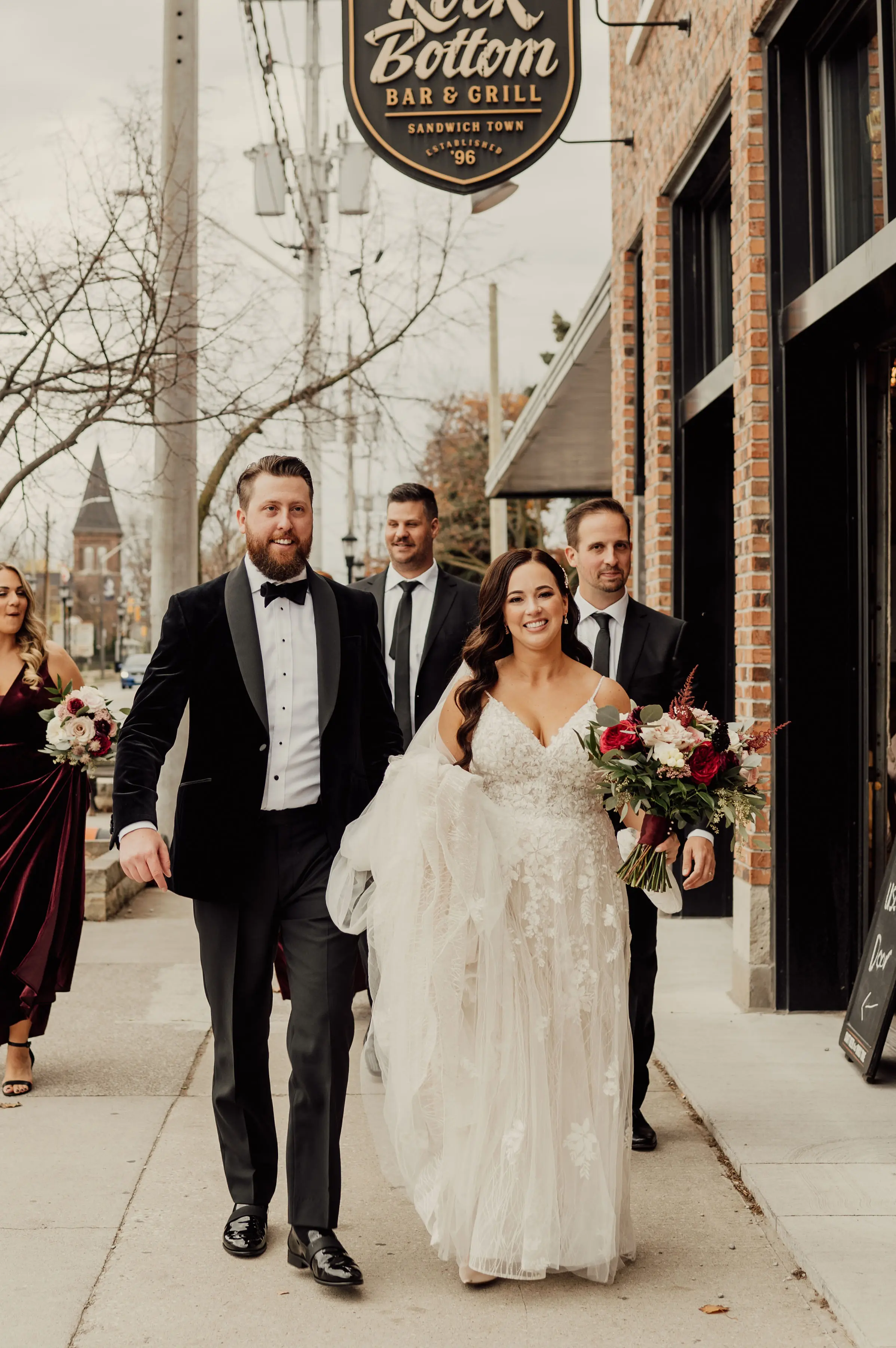 Bride Wearing Floral Lace Wedding Gown Called Laramie By Sottero And Midgley Walking On The Street With Groom