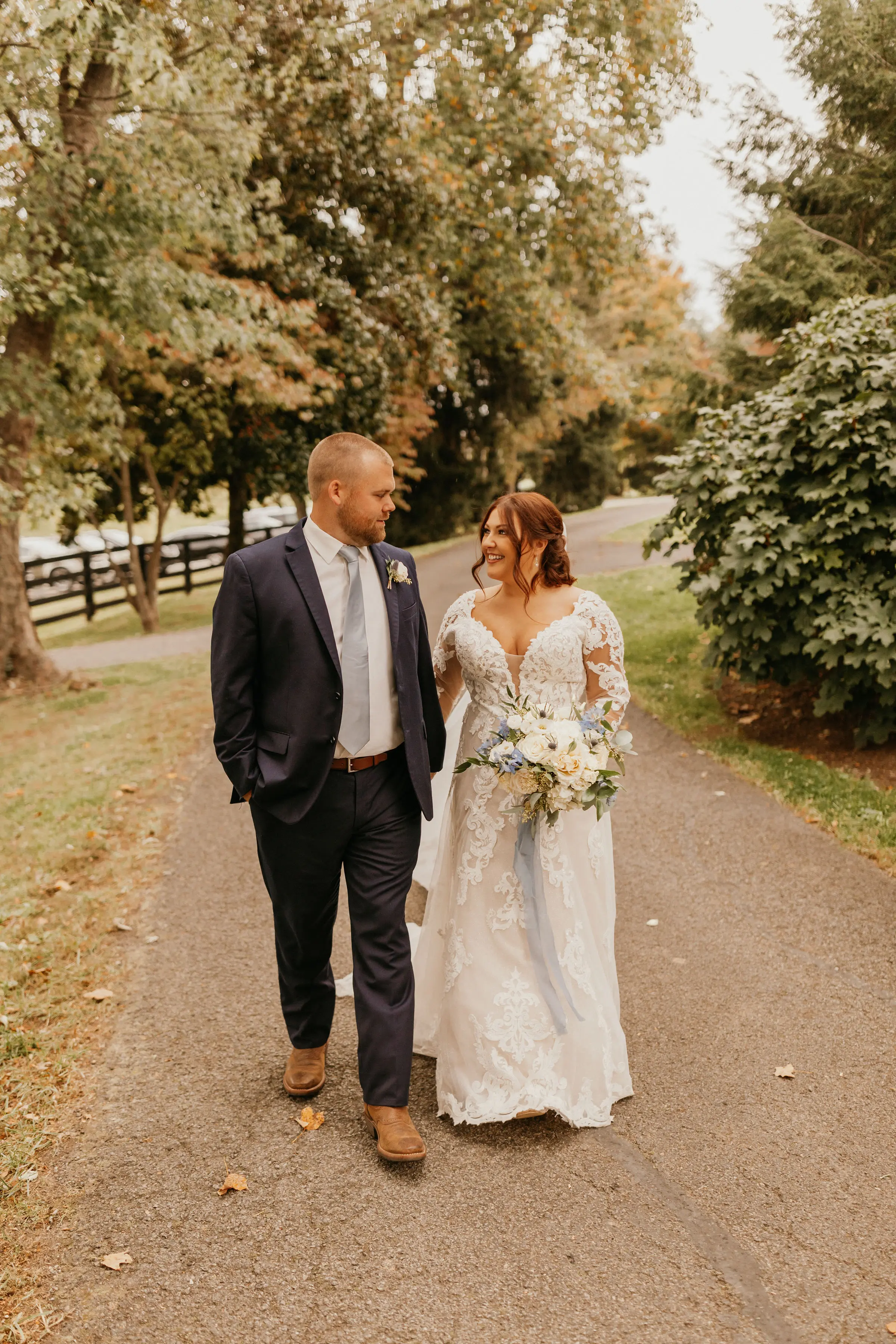 Bride wearing Lace A-line Wedding Dress called Tuscany Lane by Maggie Sottero walking with the groom