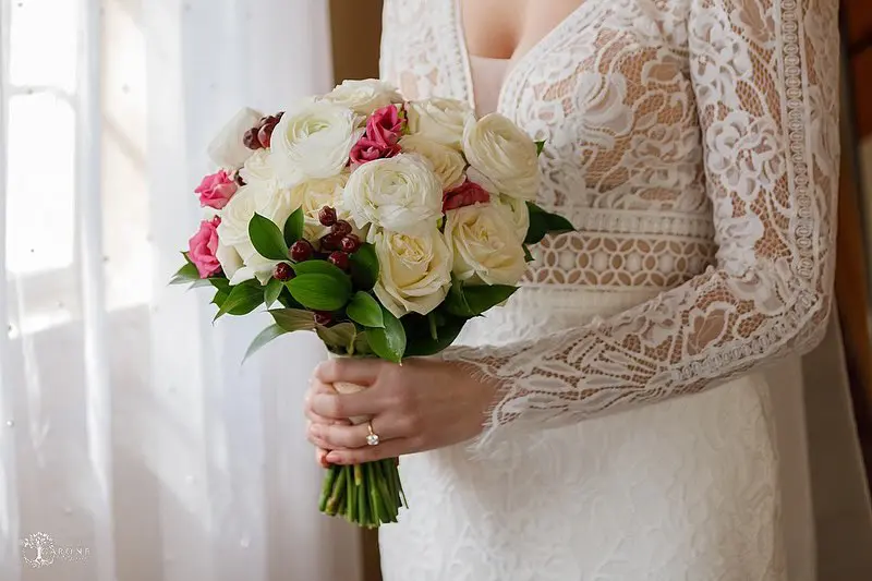 Bride Wearing Boho Sleeved Wedding Dress Called Drita By Maggie Sottero Holding Bouquet