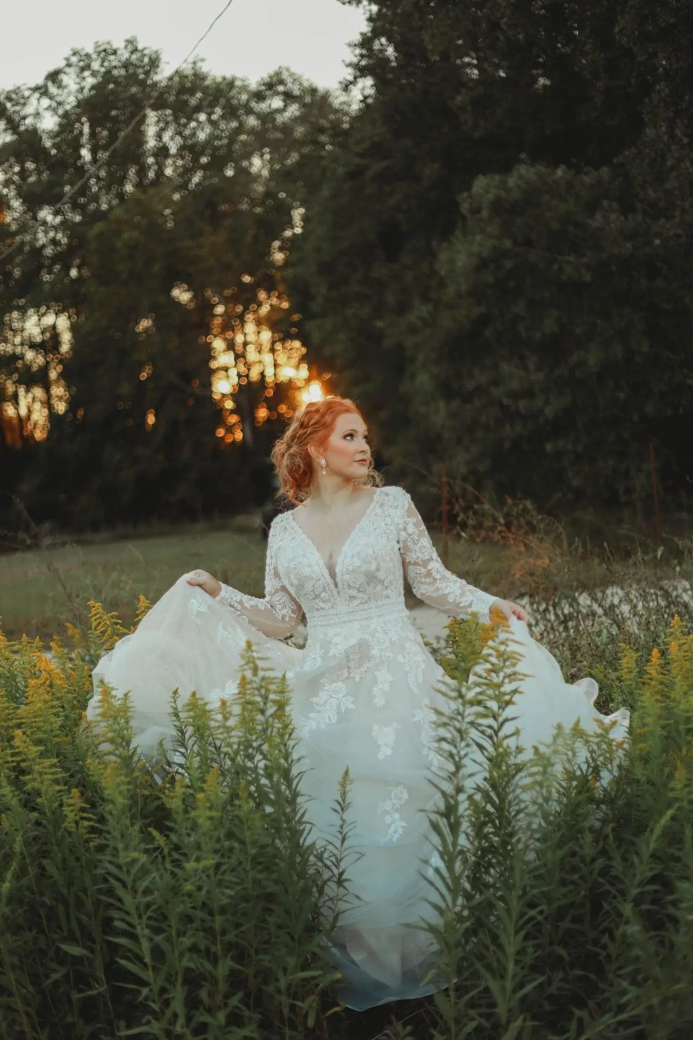 Bride Wearing Lace Long-Sleeve Wedding Gown Called Raphael By Maggie Sottero Walking Through A Field
