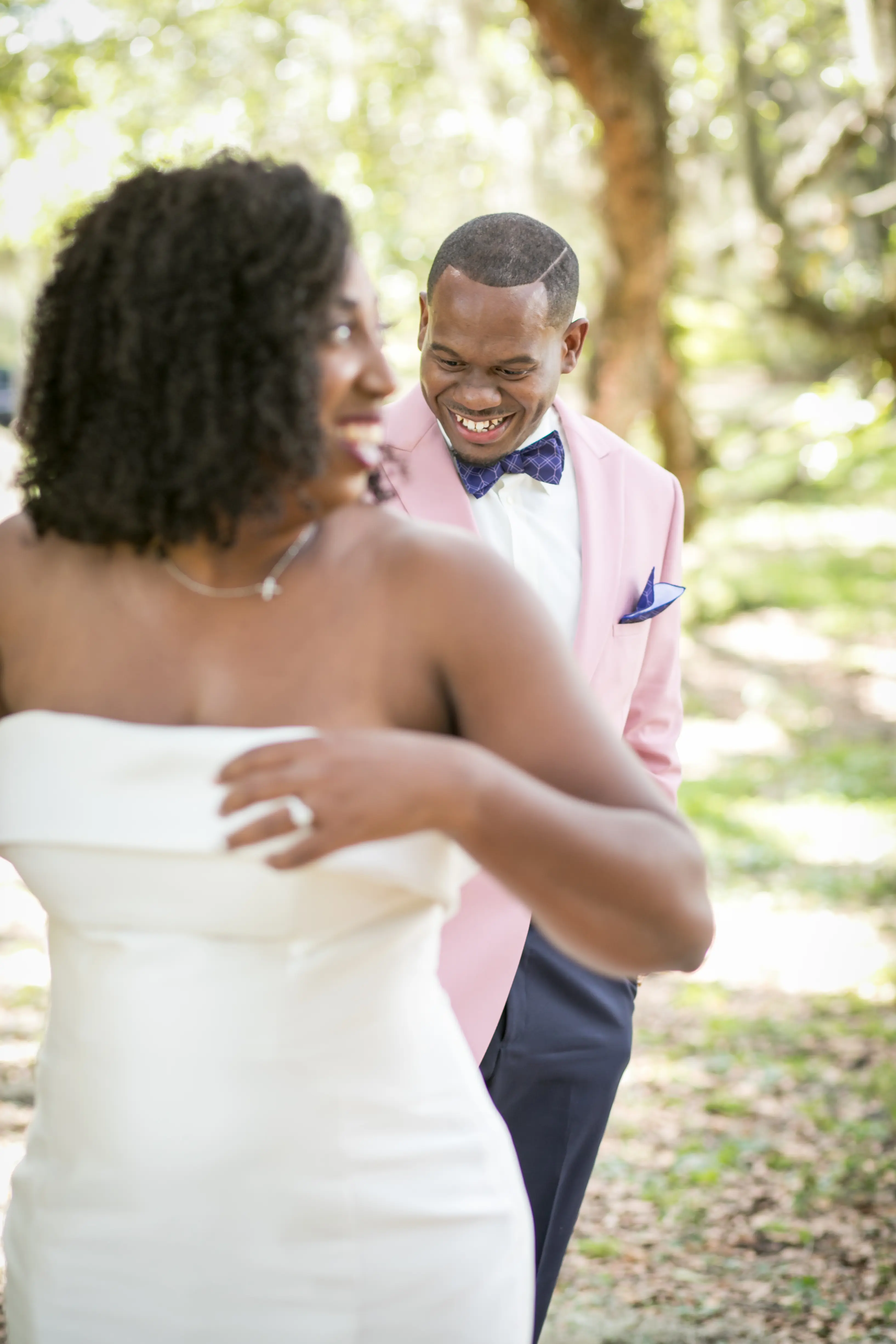 Groom Smiling With Bride In Strapless Sleek Wedding Dress Named Mitchell By Maggie Sottero