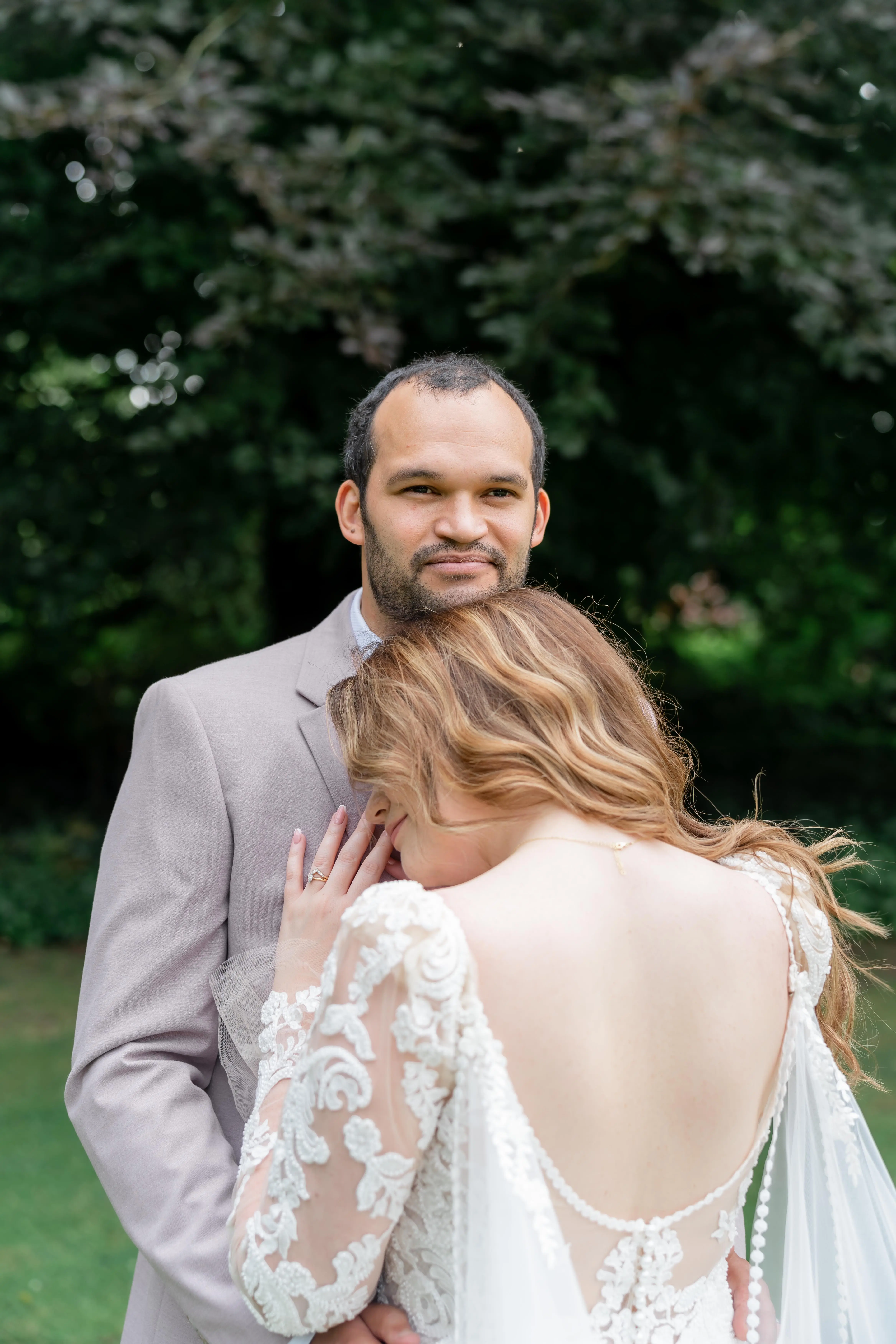 Bride wearing Nikki by Maggie Sottero resting her head on her husband