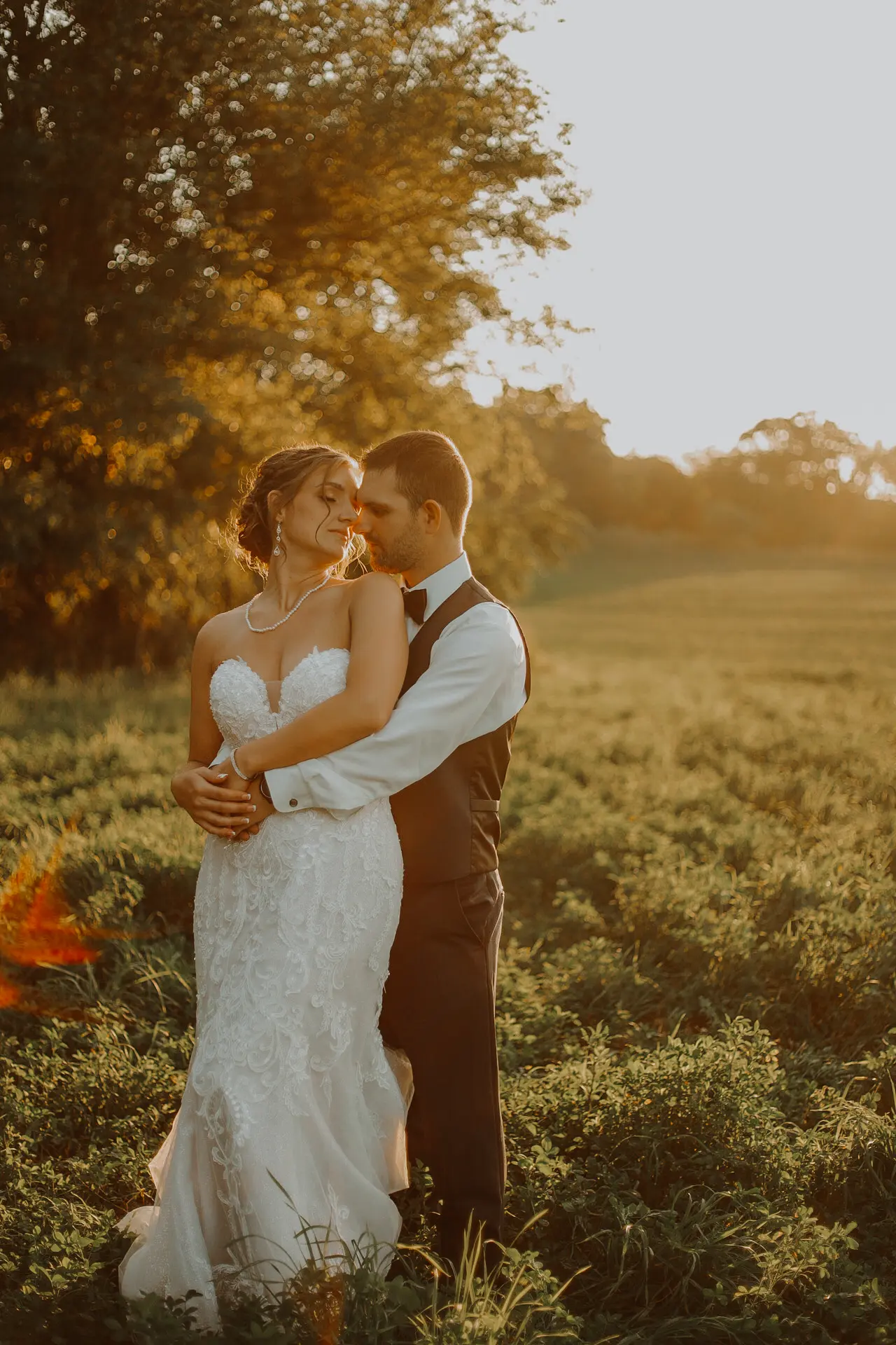 Bride wearing Marguerite wedding dress by Maggie Sottero being held by her husband