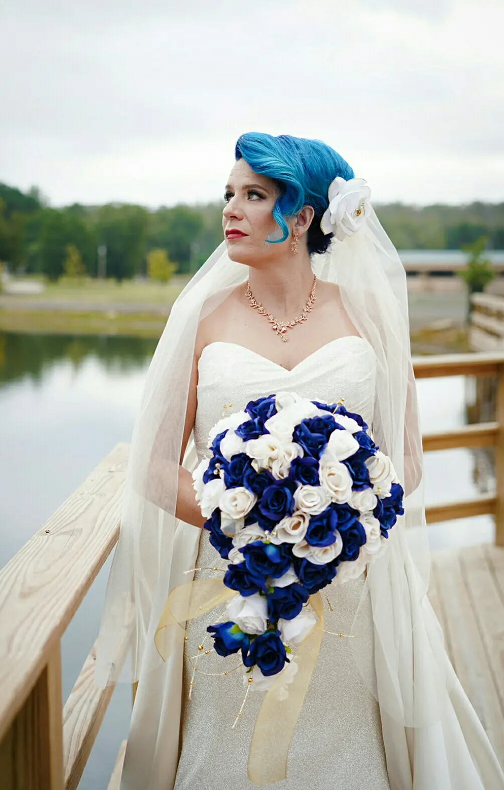 Bride Wearing Sparkly Fit-and-Flare Wedding Dress With Blue And White Bouquet