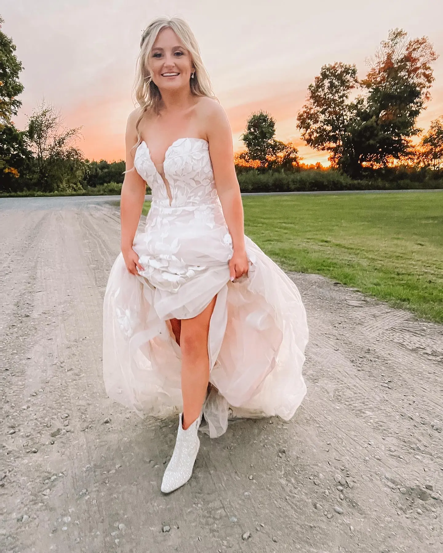Bride in floral, lace wedding dress called Hattie by Rebecca Ingram with boots