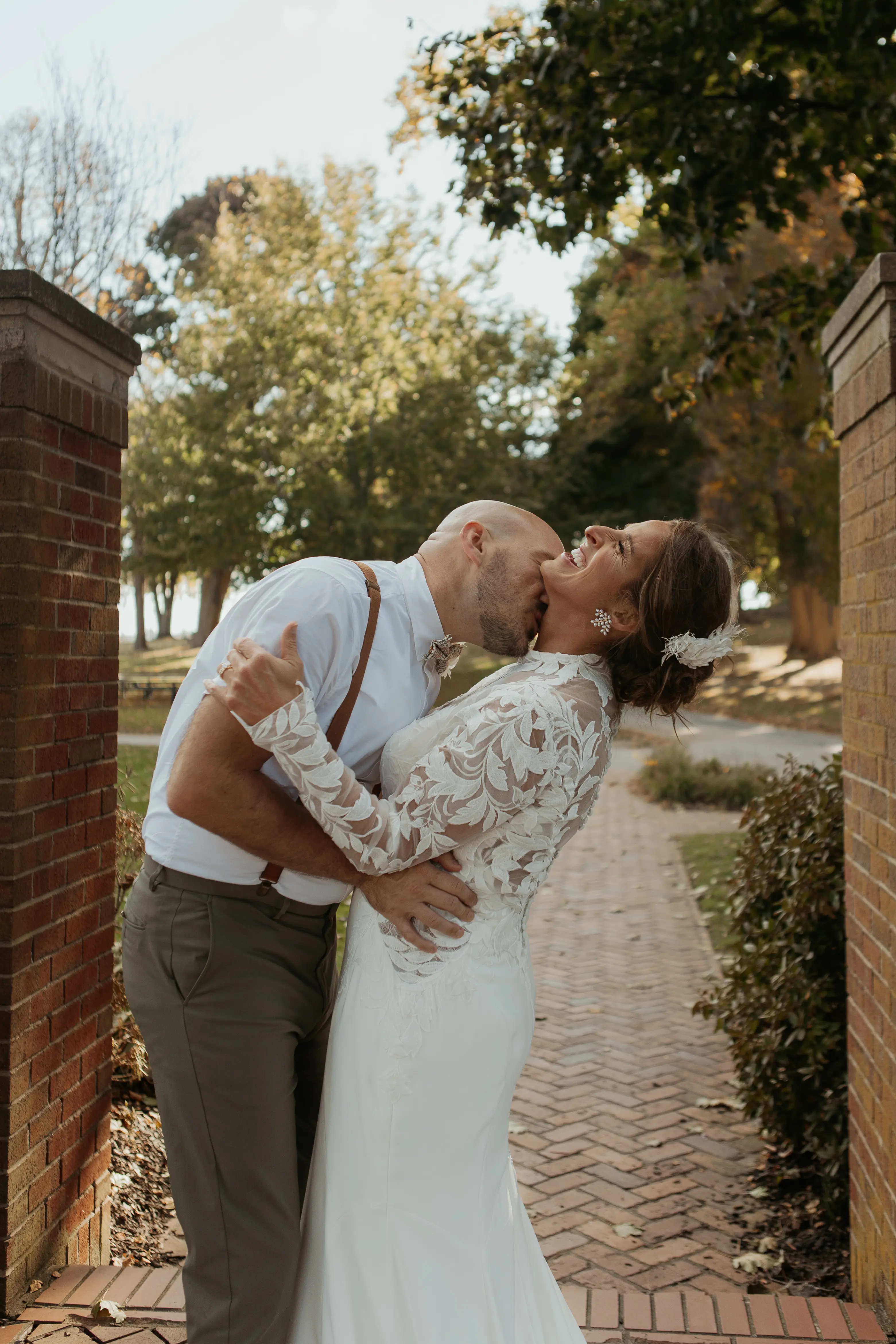 Bride Wearing Crepe Wedding Dress Called Dionne By Rebecca Ingram With Groom Kissing Her Neck