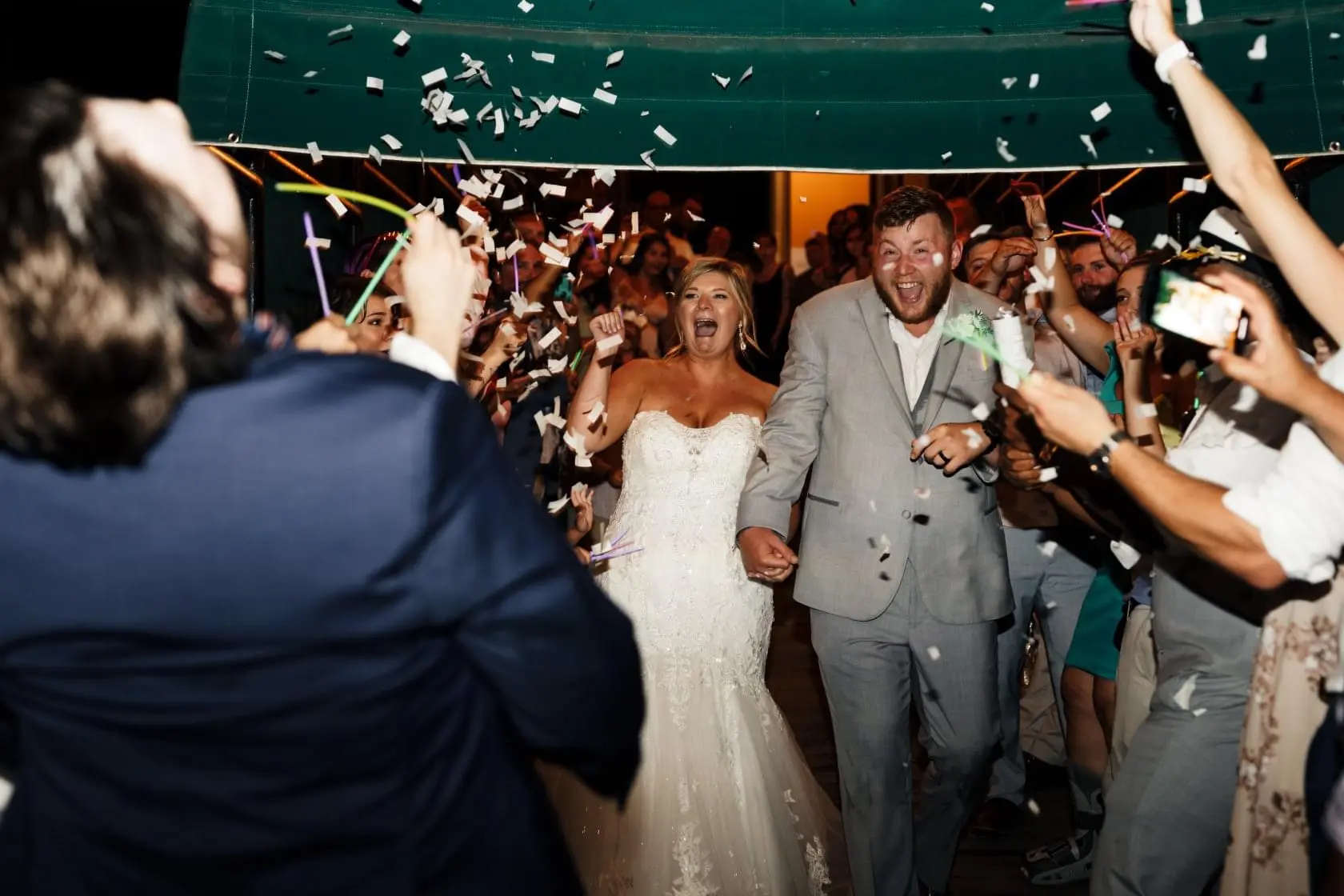Bride with groom wearing glamorous plus size mermaid wedding dress