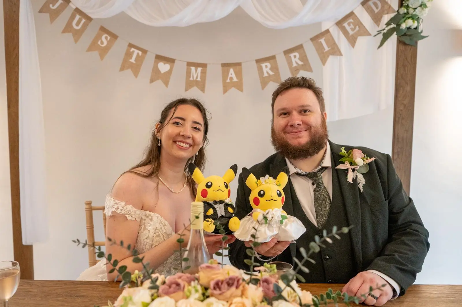 Bride wearing Harlem by Maggie Sottero with her husband holding pikachu toys