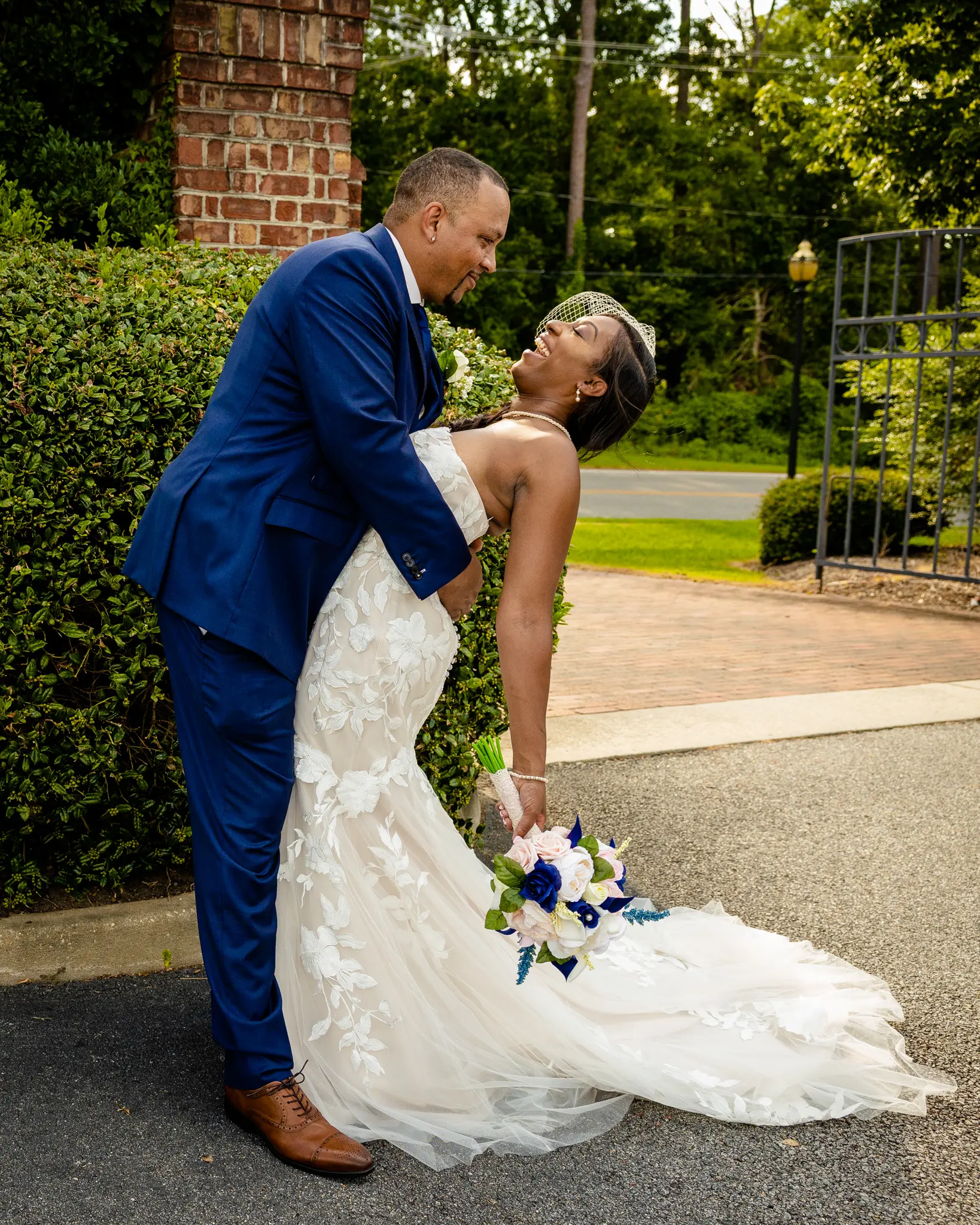 Groom With Bride Wearing Strapless Mermaid Wedding Dress With Oversized Lace Hattie By Rebecca Ingram