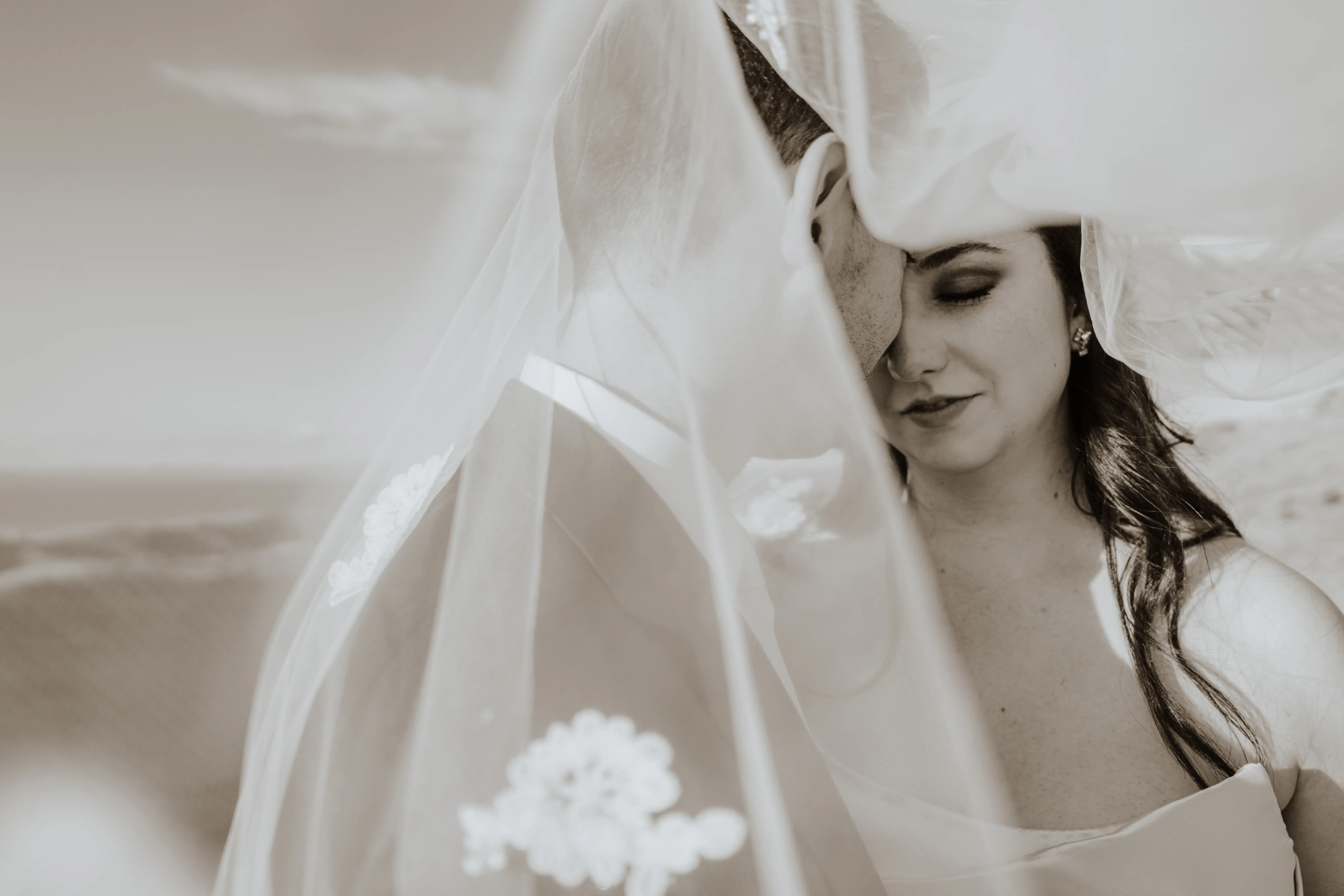 Bride wearing Aspen by Sottero and Midgley with her husband under her veil