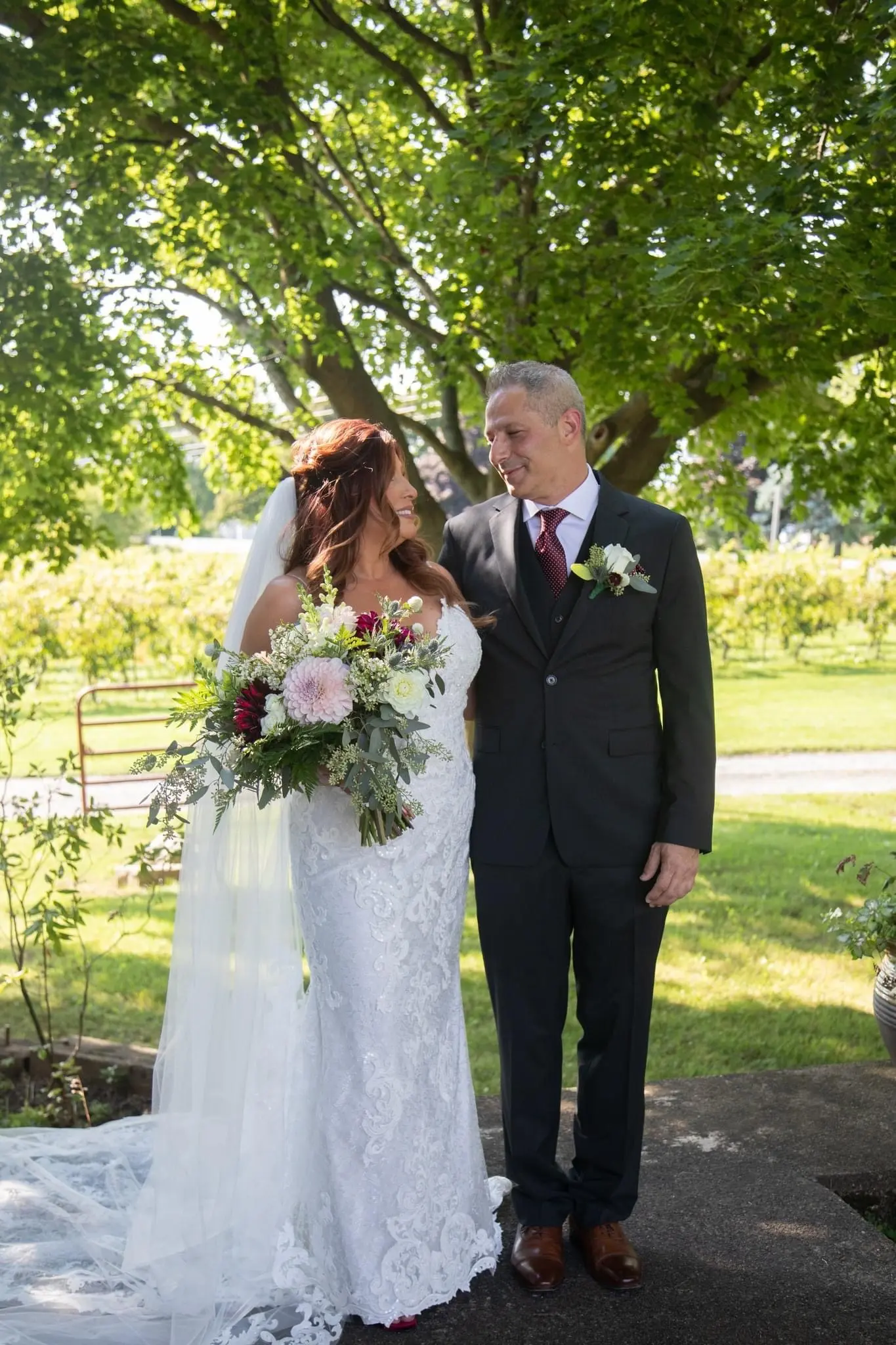 Bride Wearing Sexy Mermaid Wedding Dress Called Tuscany By Maggie Sottero Gazing At Groom Under Tree