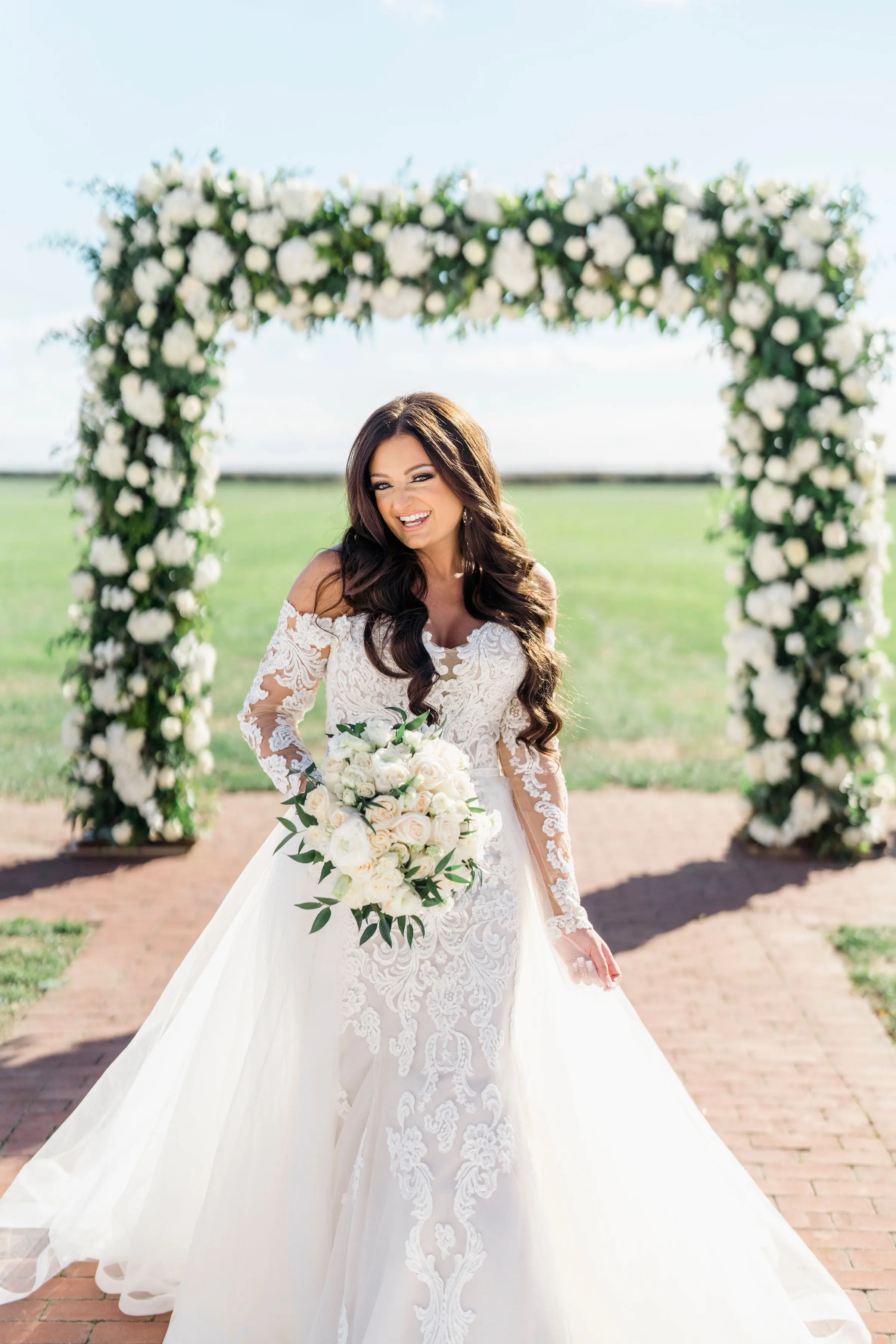 Bride Wearing Sparkly Lace Fit-and-Flare Wedding Dress Walking Down Aisle Outdoors.