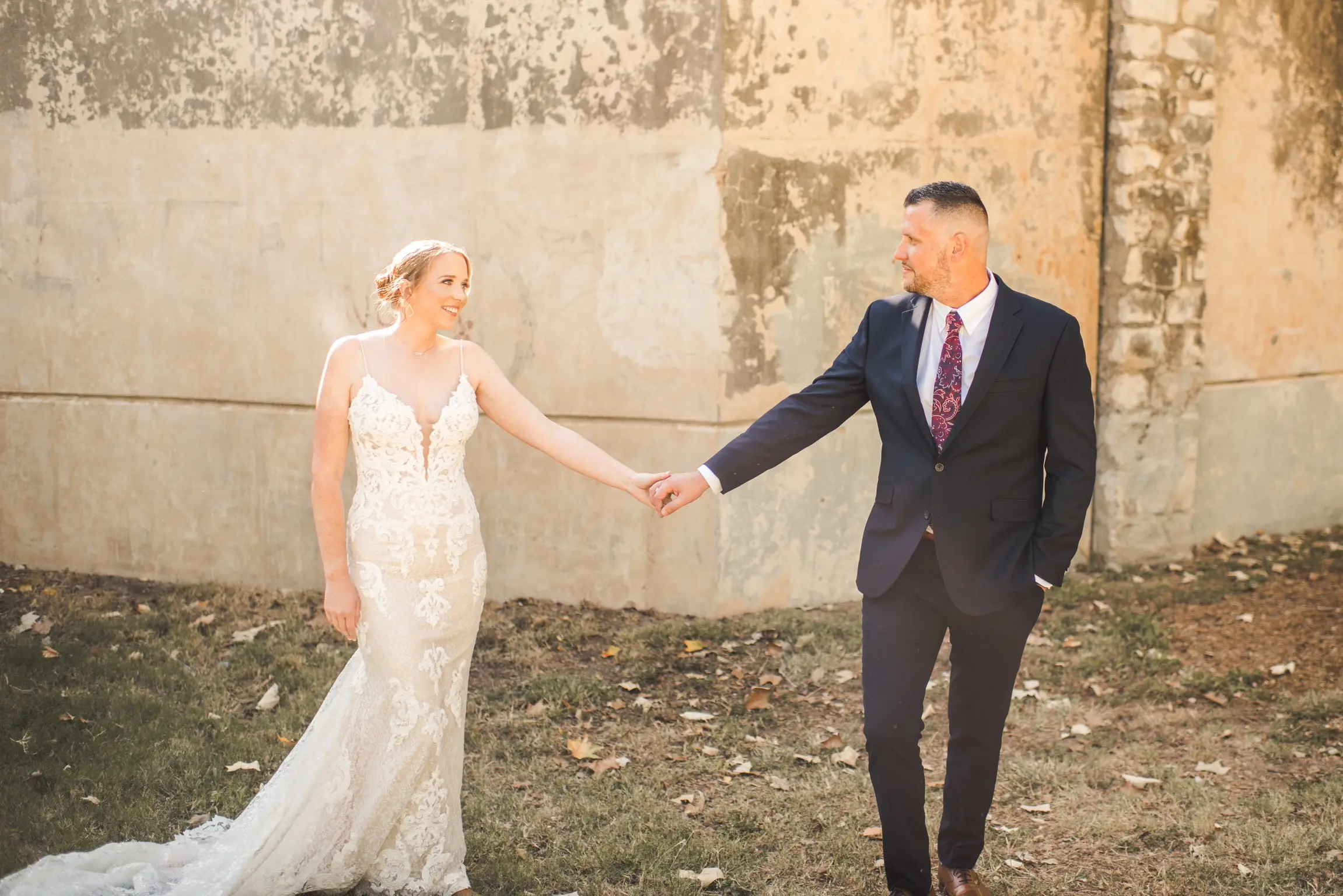 Bride Wearing Glamorous Lace And Sequin Wedding Dress Called Tuscany By Maggie Sottero Holding Hands Looking At Groom