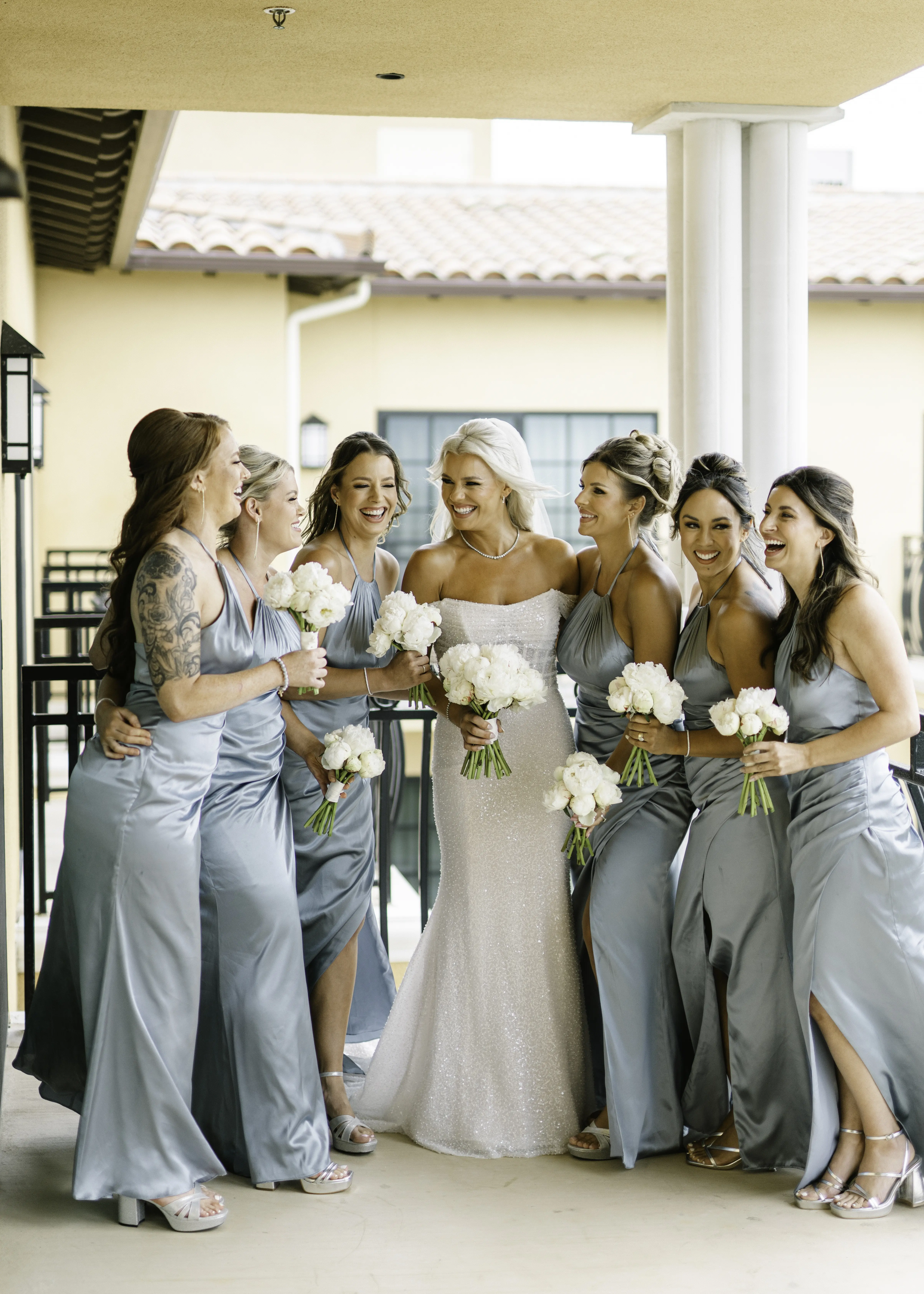Bride Wearing Pearl Sparkly Bridal Gown Called Drew By Maggie Sottero Laughing With Bridesmaids