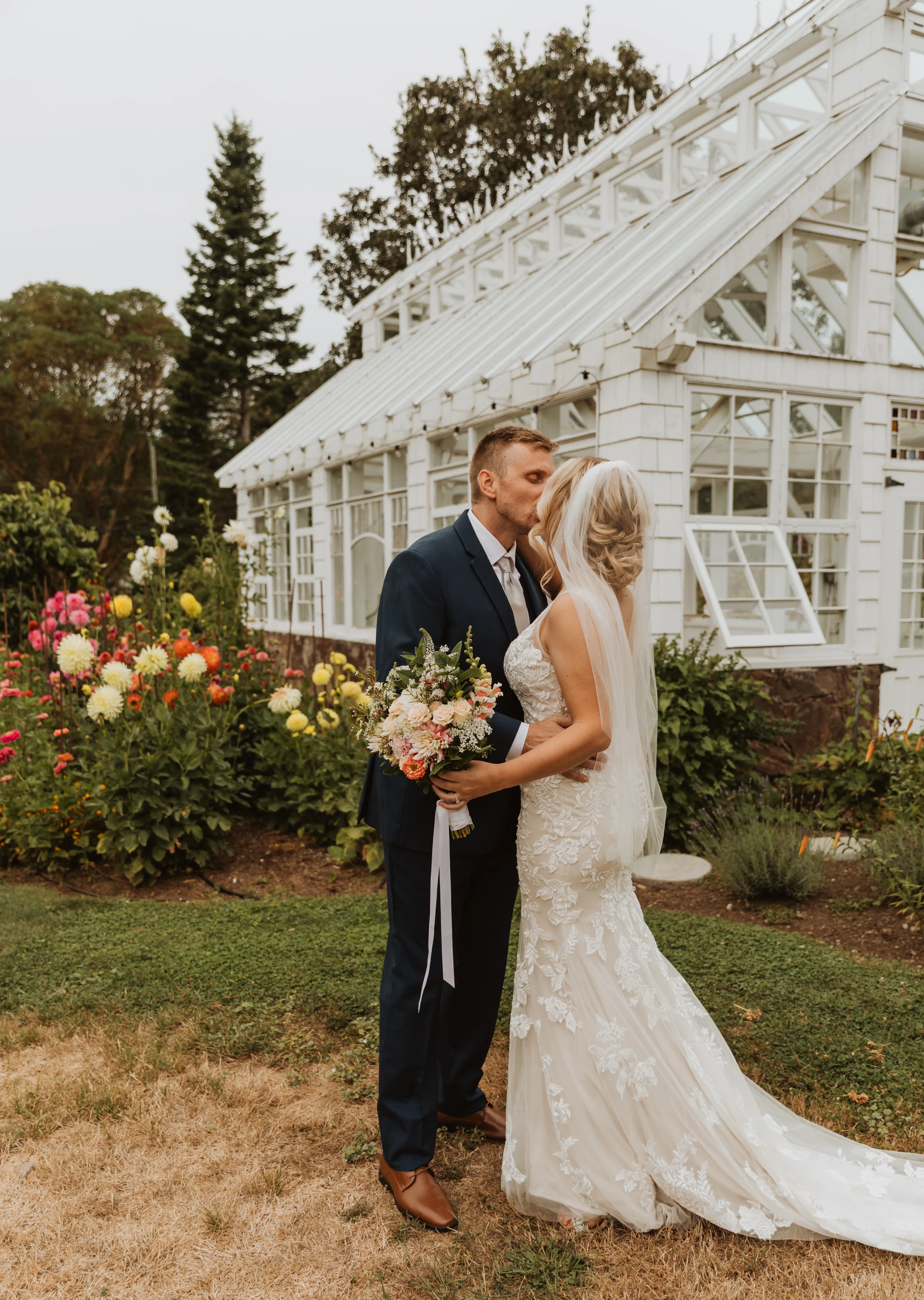 Bride wearing Greenley wedding dress by Maggie Sottero kissing her husband