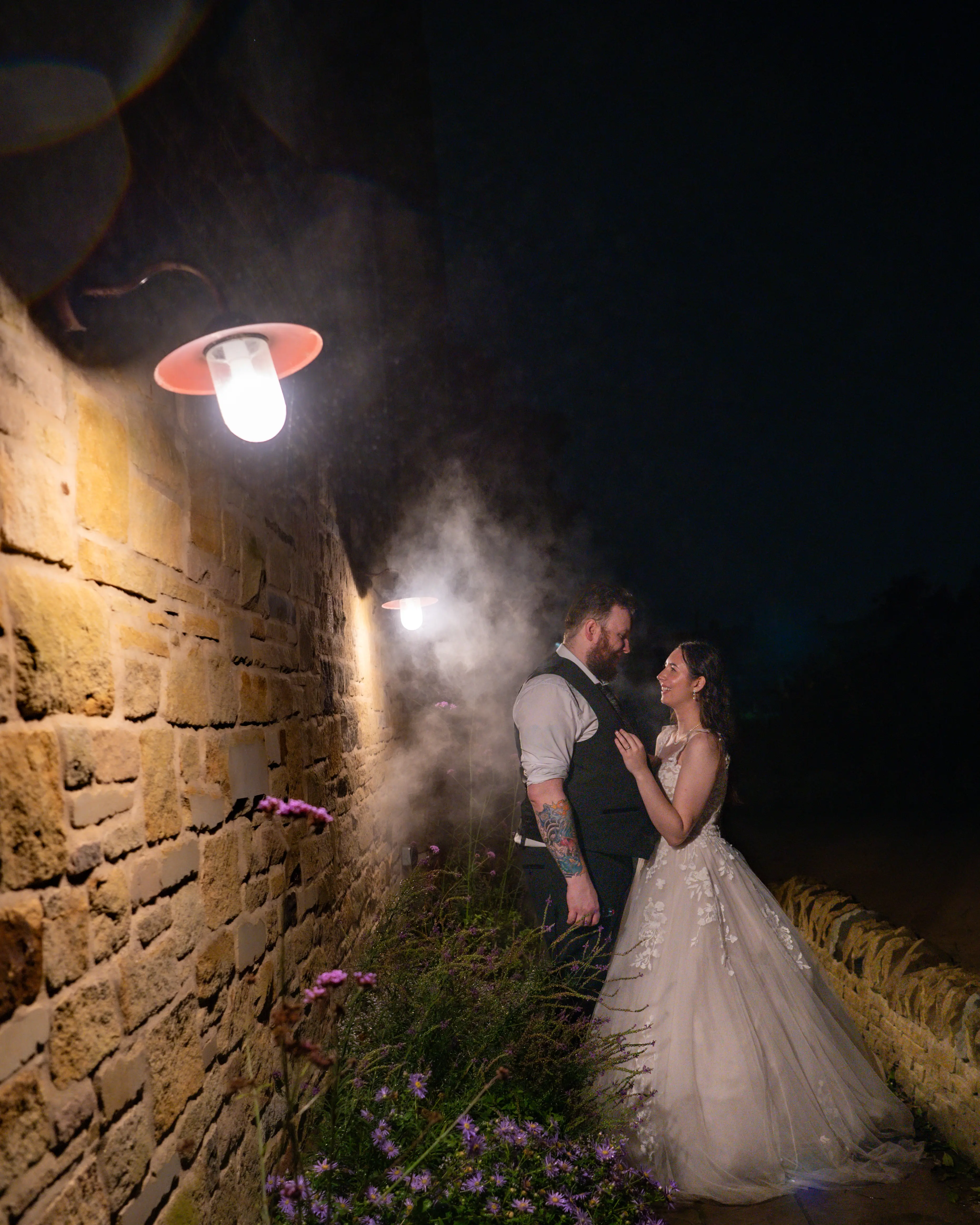 Bride wearing Harlem by Maggie Sottero outside with her husband at night