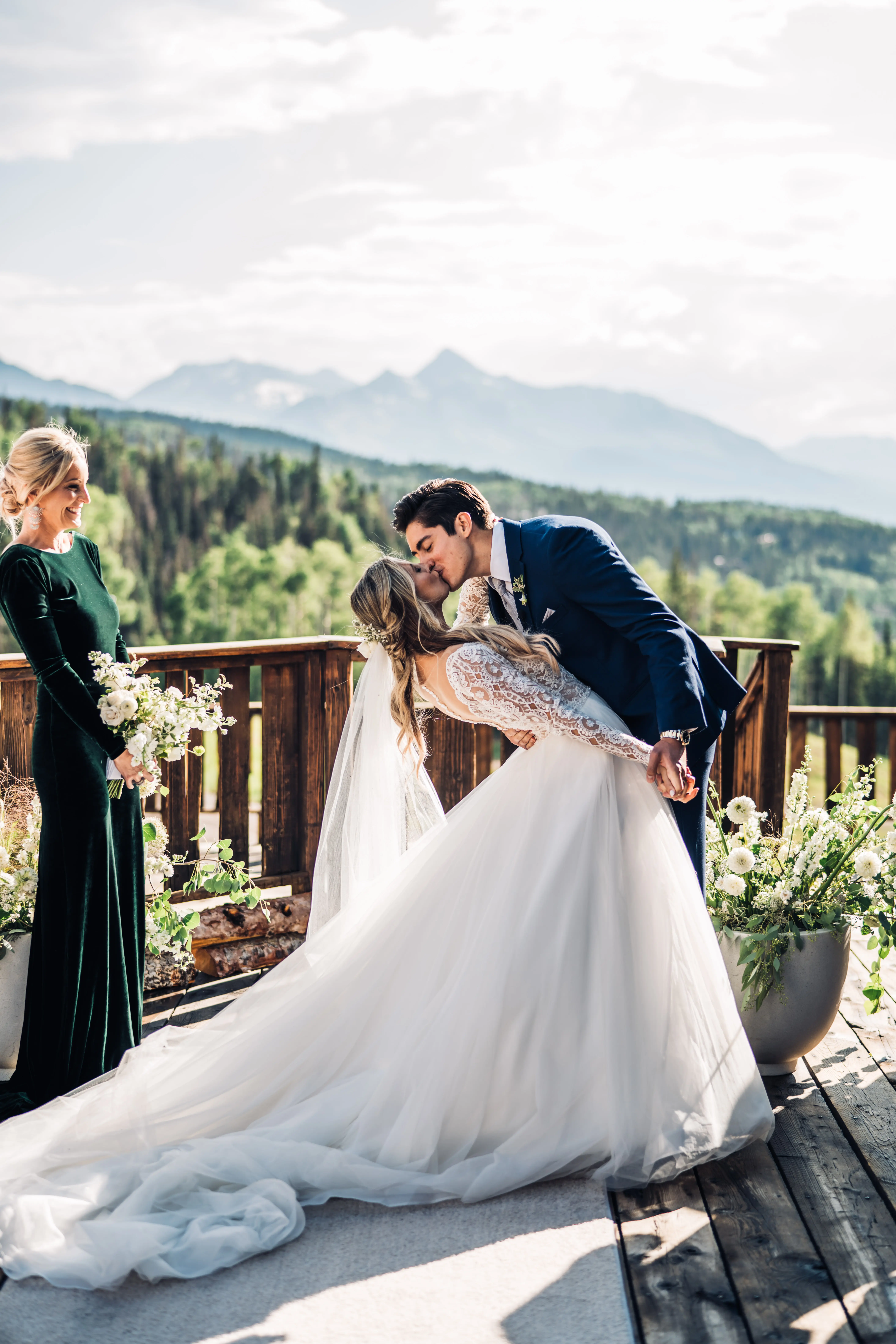 Bride with groom wearing long sleeve lace ballgown wedding dress