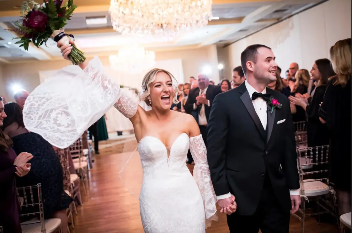 Bride Wearing Boho Sleeved Wedding Dress Bronson By Sottero And Midgley Holding Hands With Groom