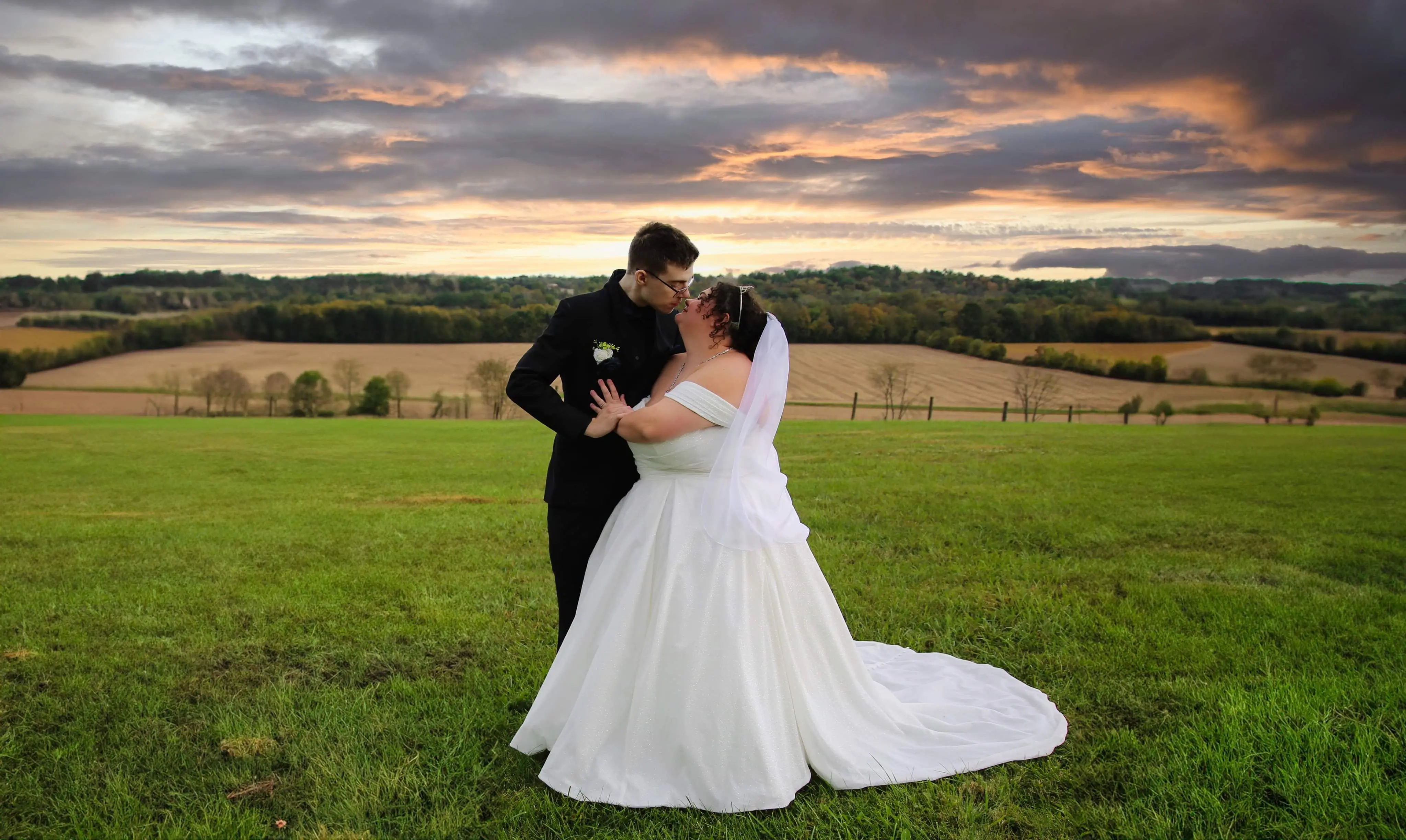 Bride wearing Anniston by Maggie Sottero kissing her husband