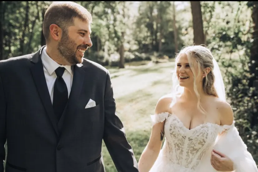 Bride Wearing Lace Aline Bridal Gown Called Harlem By Maggie Sottero Smiling At Groom