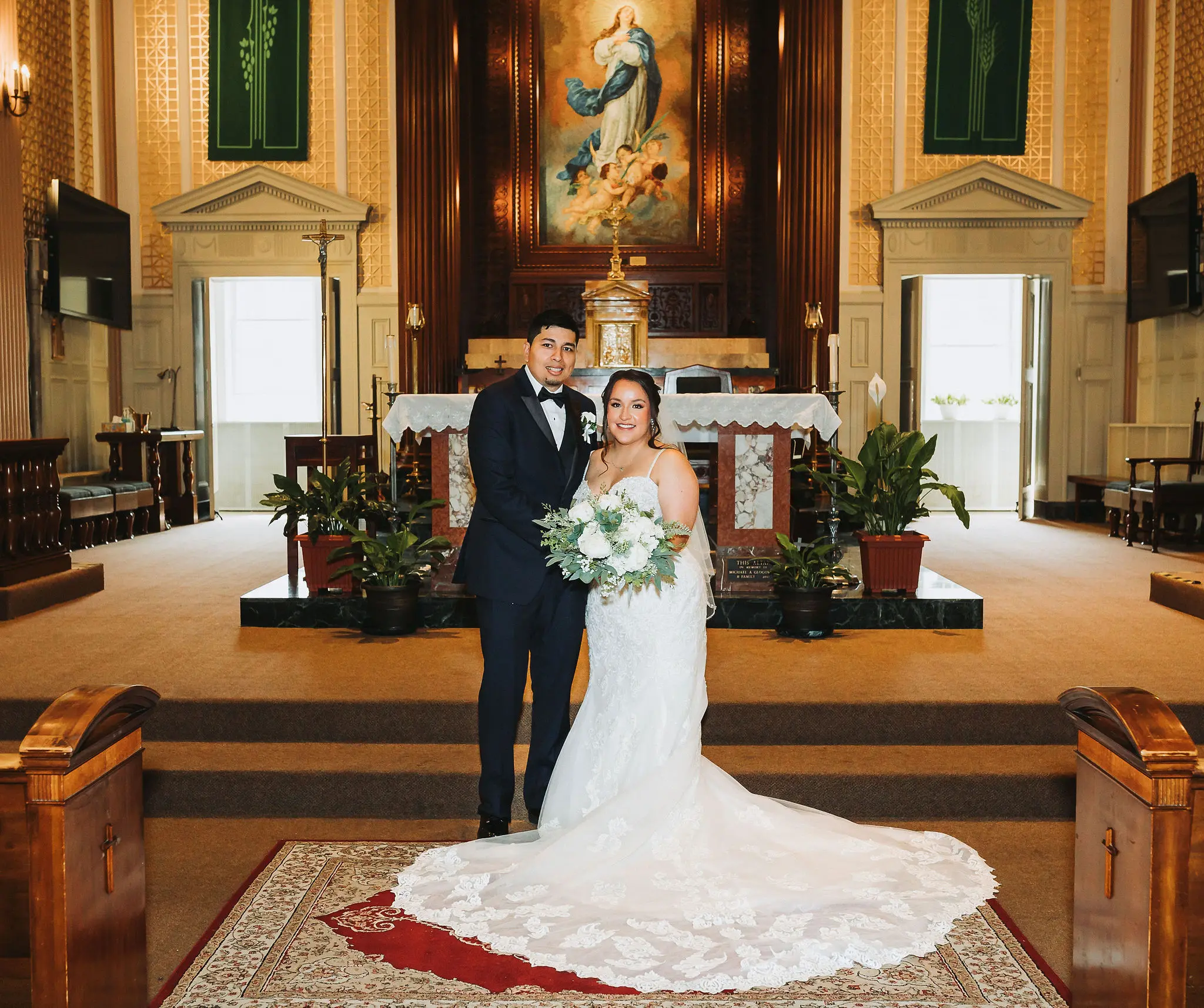 Bride wearing Fiona wedding dress by Maggie Sottero standing at the alter with her husband
