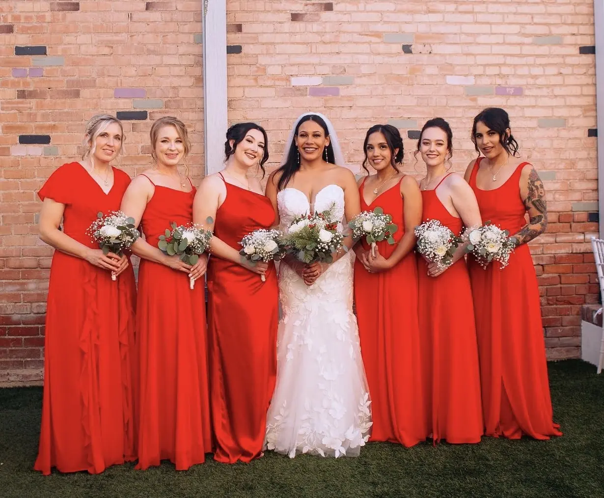 bride in sexy floral wedding dress called hattie by rebecca ingram with bridesmaids in red dresses