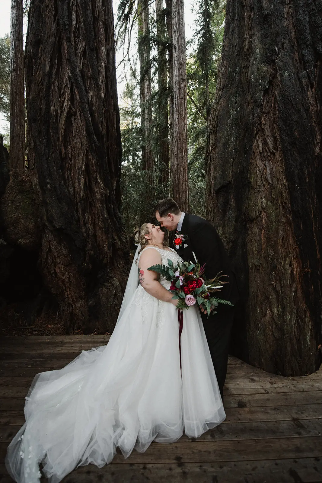 Groom Holding Bride in Ball Gown Wedding Dress Named Talia By Maggie Sottero