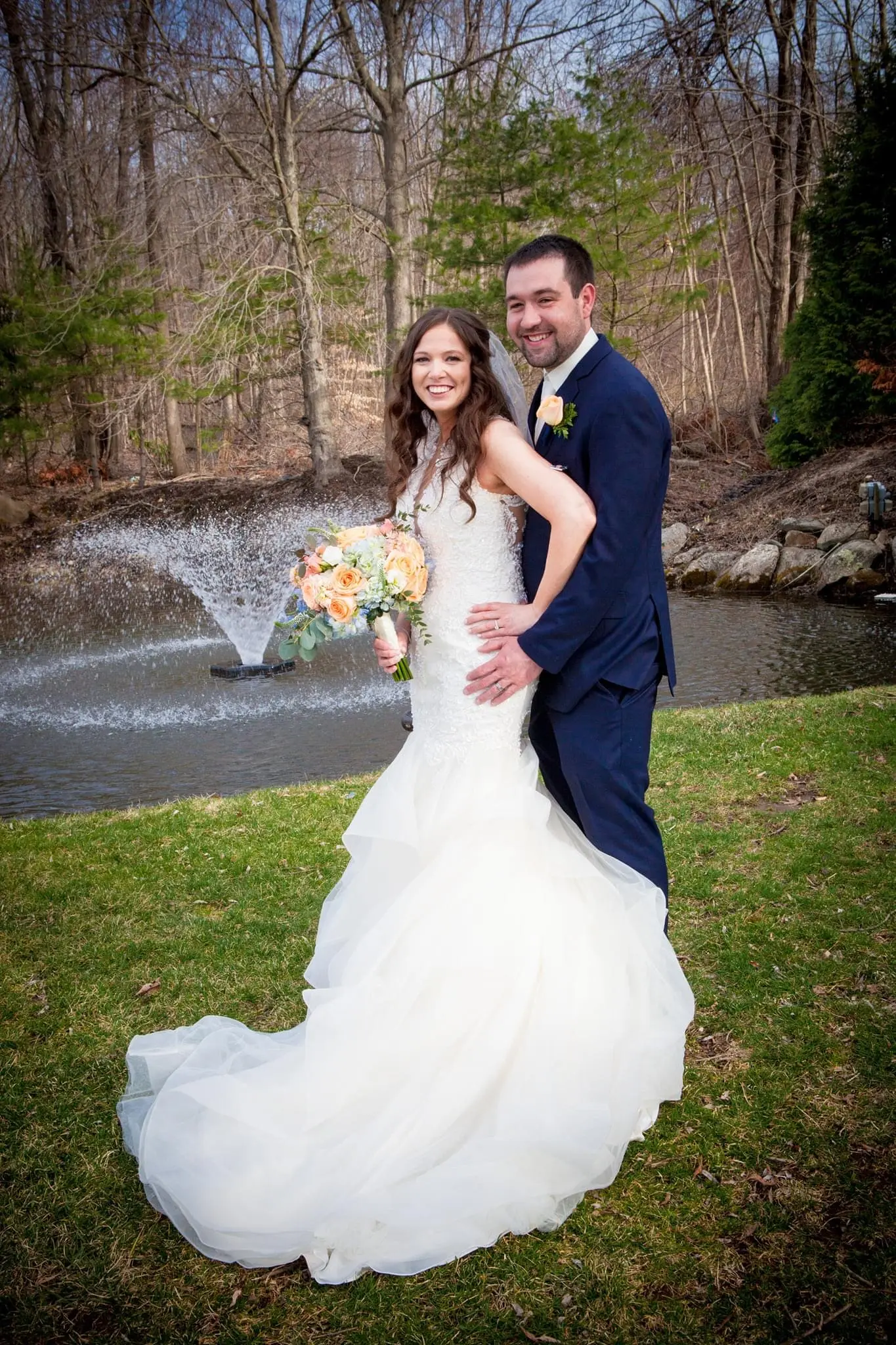 Bride with groom wearing organza mermaid wedding dress